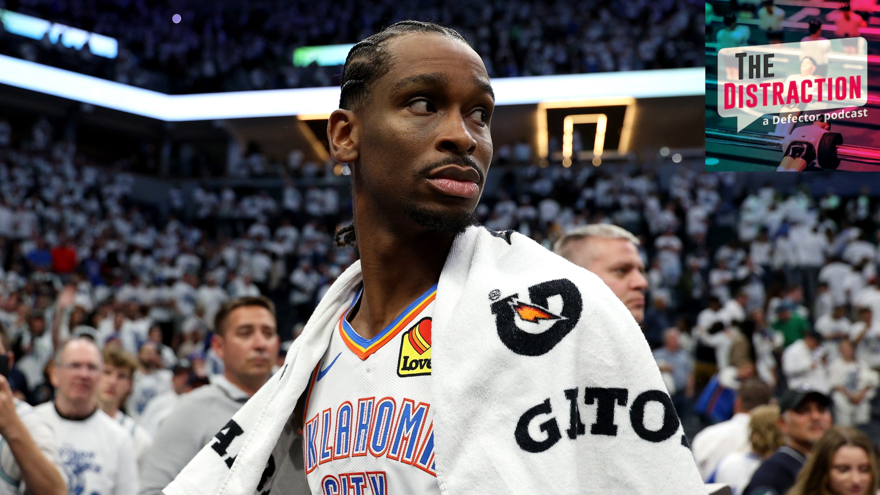 Shai Gilgeous-Alexander of the Oklahoma City Thunder looks to his right, seemingly at The Distraction logo, with a towel over his shoulder, after the team's Game 4 loss in the Western Conference Finals.