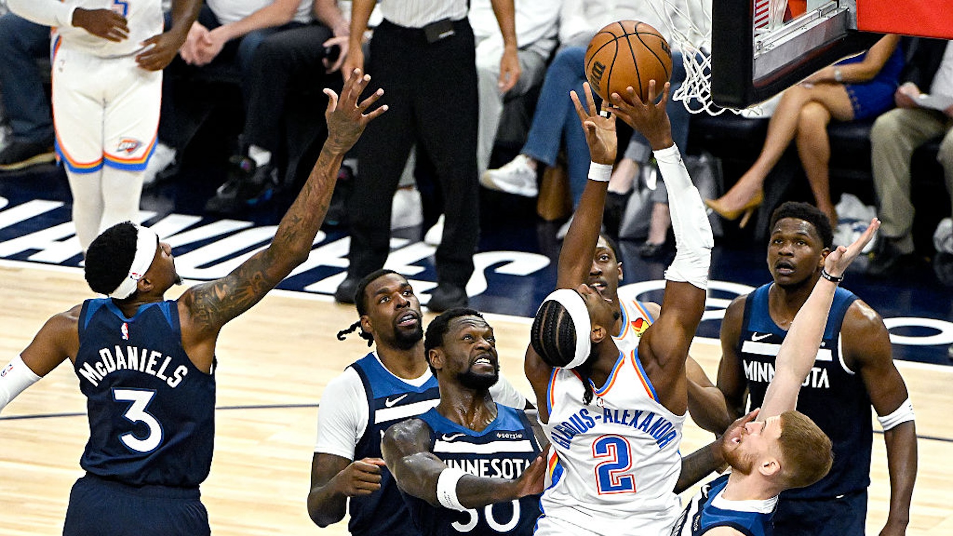 Shai Gilgeous-Alexander #2 of the Oklahoma City Thunder shoots the ball against Julius Randle #30 and Donte DiVincenzo #0 of the Minnesota Timberwolves during the first quarter in Game Four of the Western Conference Finals of the 2025 NBA Playoffs at Target Center on May 26, 2025 in Minneapolis, Minnesota. NOTE TO USER: User expressly acknowledges and agrees that, by downloading and or using this photograph, User is consenting to the terms and conditions of the Getty Images License Agreement.