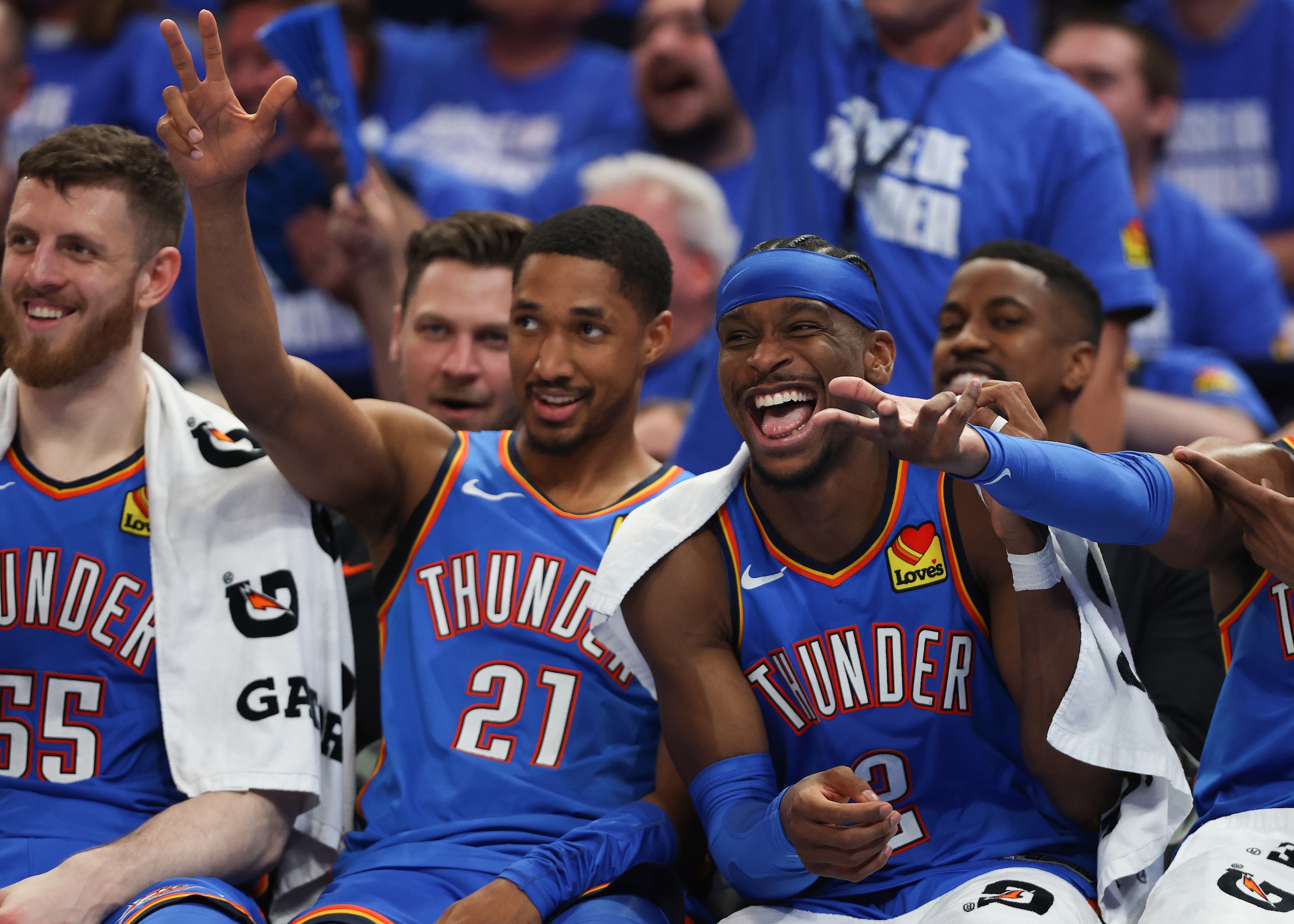 Thunder players smile on the sideline during their victory.