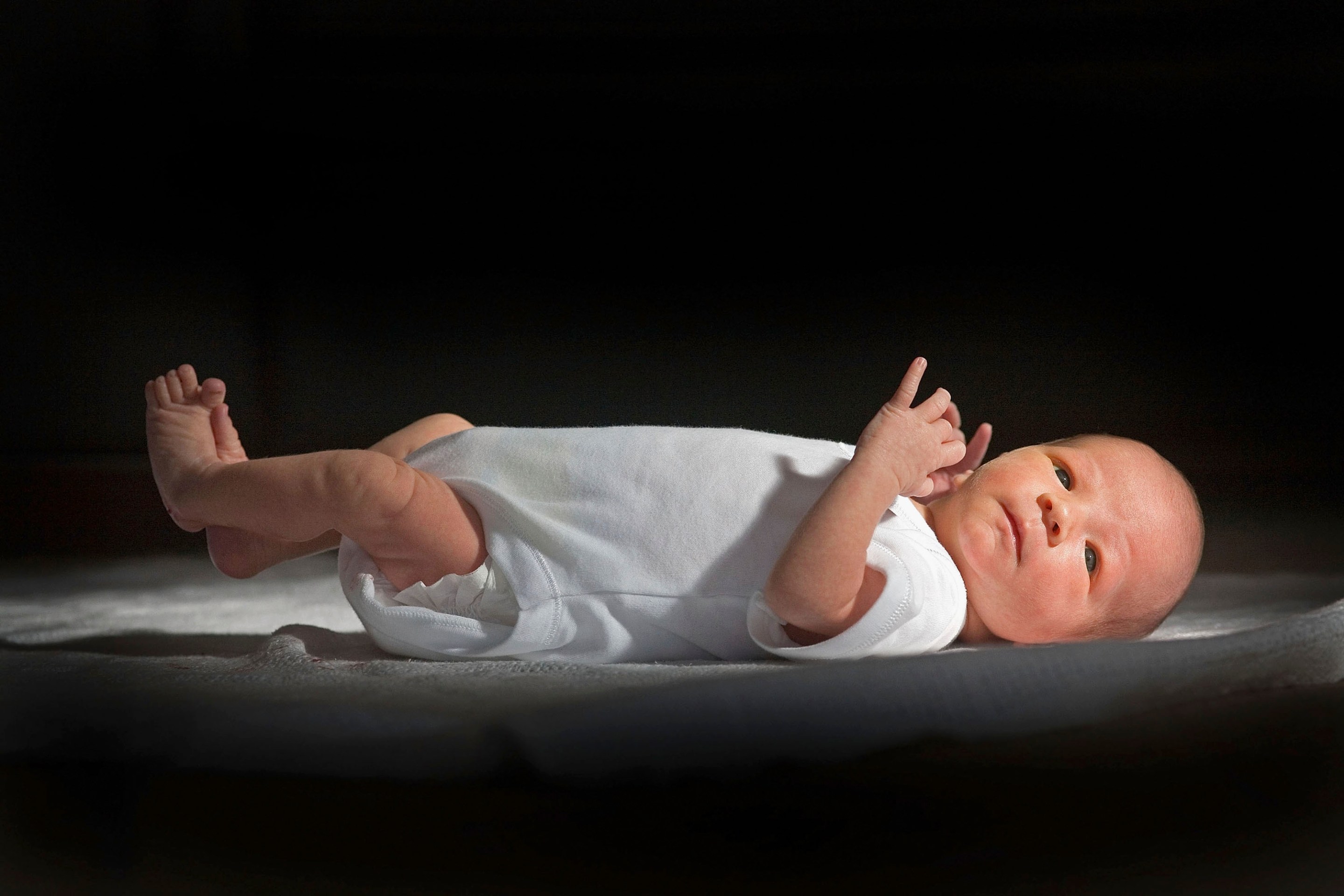 KNUTSFORD, UNITED KINGDOM - (FILE) In this file photograph taken in March 12, 2007, a two-week-old boy eyes his new world. Health Secretary Patricia Hewitt announnced, April 3, 2007 that for the first time, mothers-to-be will have a guarantee that the NHS will provide them with a full range of birthing choices - including home births - and a midwife they know and trust to care for them. (Photo by Christopher Furlong/Getty Images)