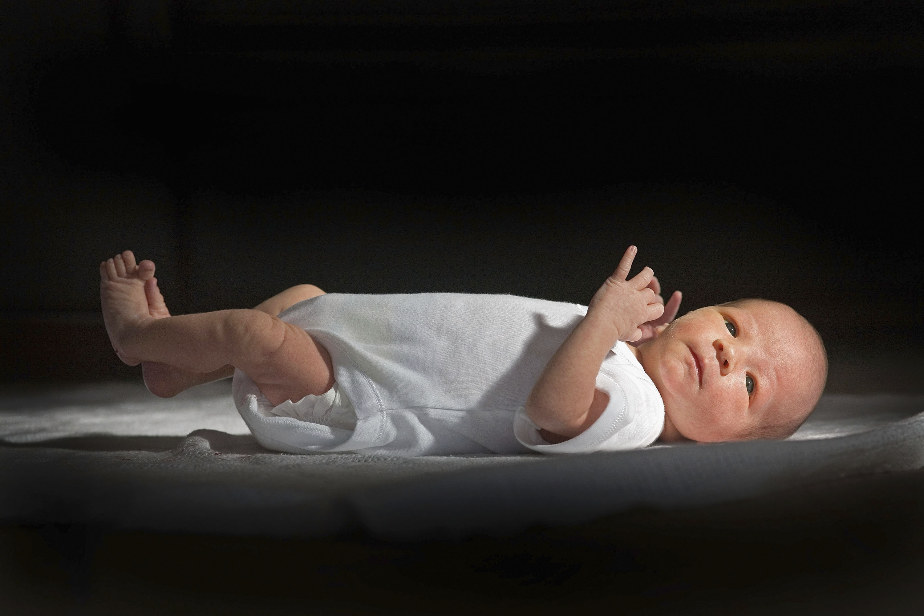 KNUTSFORD, UNITED KINGDOM - (FILE) In this file photograph taken in March 12, 2007, a two-week-old boy eyes his new world. Health Secretary Patricia Hewitt announnced, April 3, 2007 that for the first time, mothers-to-be will have a guarantee that the NHS will provide them with a full range of birthing choices - including home births - and a midwife they know and trust to care for them. (Photo by Christopher Furlong/Getty Images)