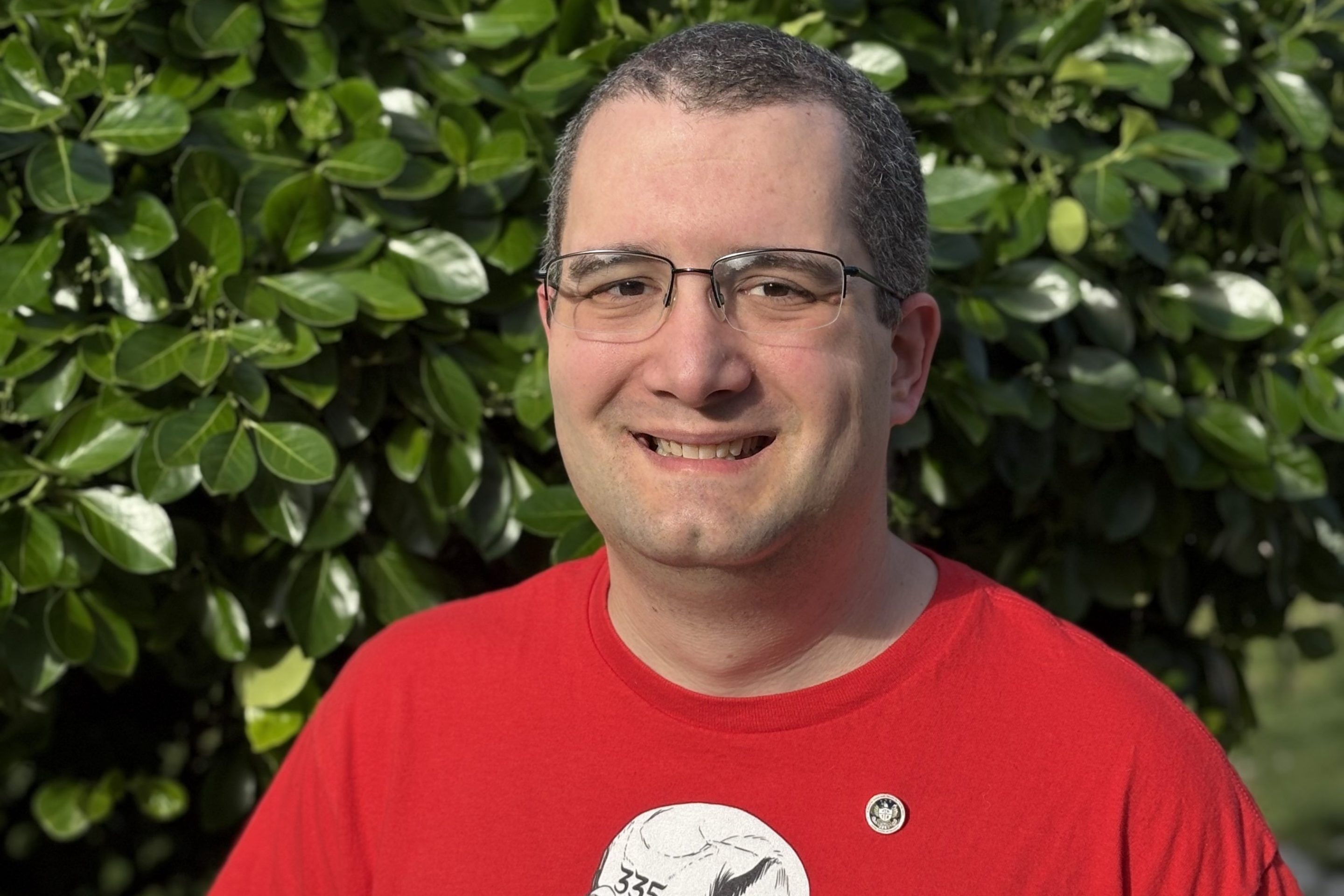 a photo of Chuck Sebian-Lander, a fired CFPB web manager. He is wearing a a shirt from my union, NTEU 335, and b) a lapel pin with the CFPB seal that he was given as part of a Director's award
