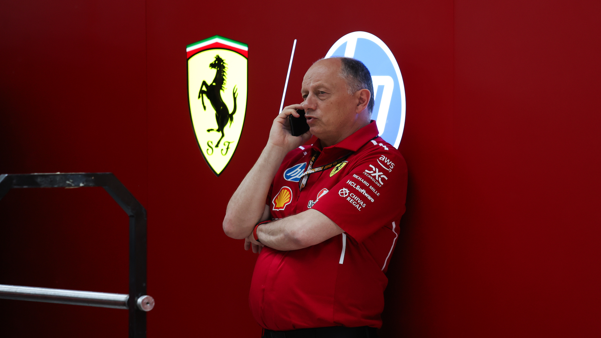 Frederic Vasseur speaks on the phone outside of the Ferrari garage in the Miami International Autodrome paddock.