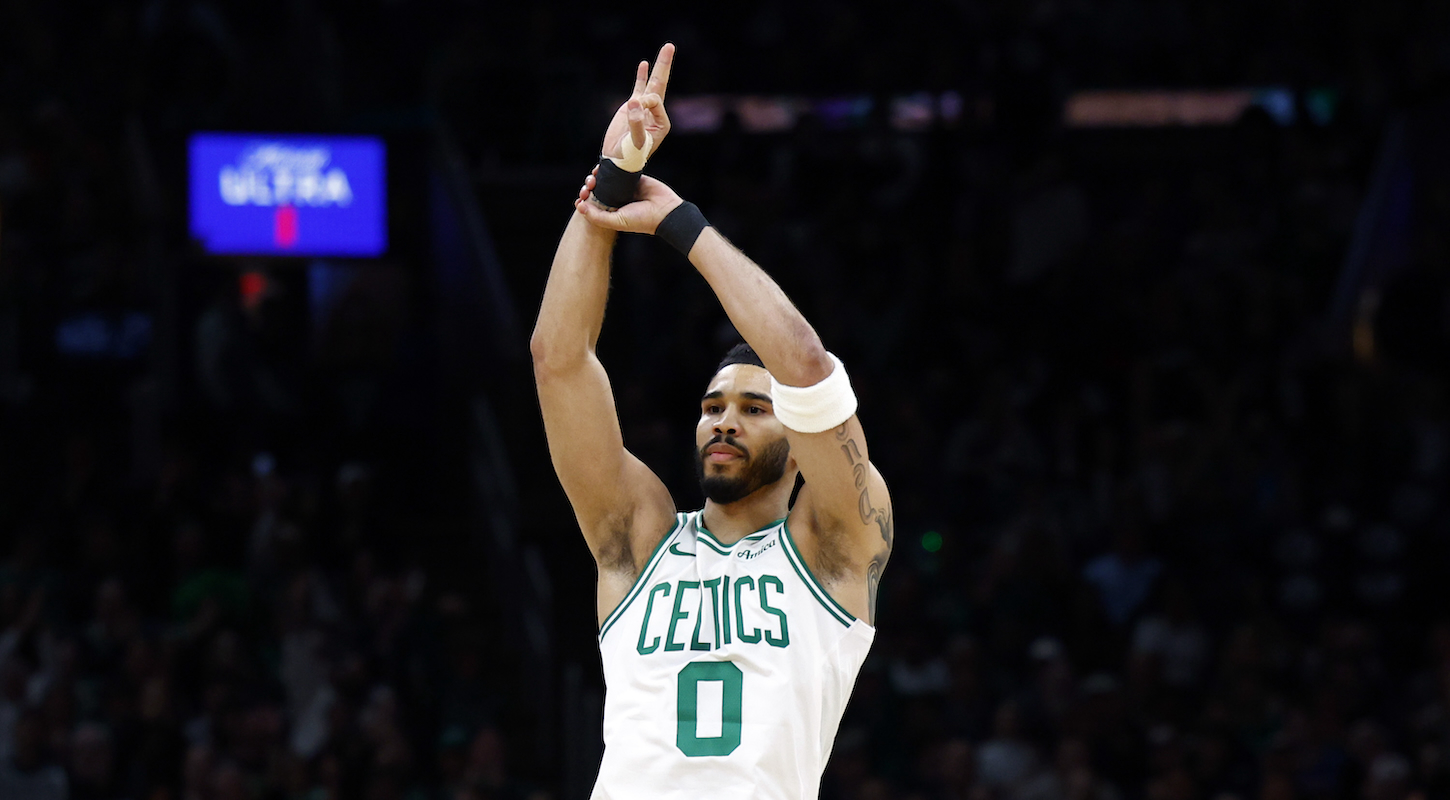 Jayson Tatum holds up three fingers to celebrate making a three-pointer in a game in which the Celtics missed an NBA playoff–record 45 threes, and lost in overtime.