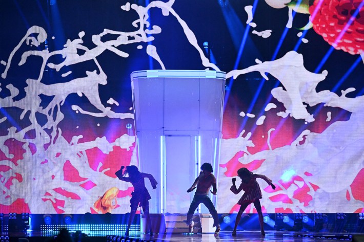 The Milkshake Man, Go-Jo- dances on stage. The screen is a milkshake but it looks like cum.