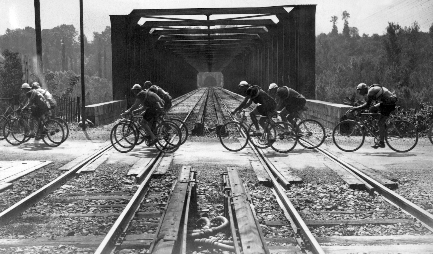 The pack of the Tour de France cross a railway line during a stage of the Great Loop, in July 1933. (Photo by STF / AFP) (Photo credit should read STF/AFP via Getty Images)