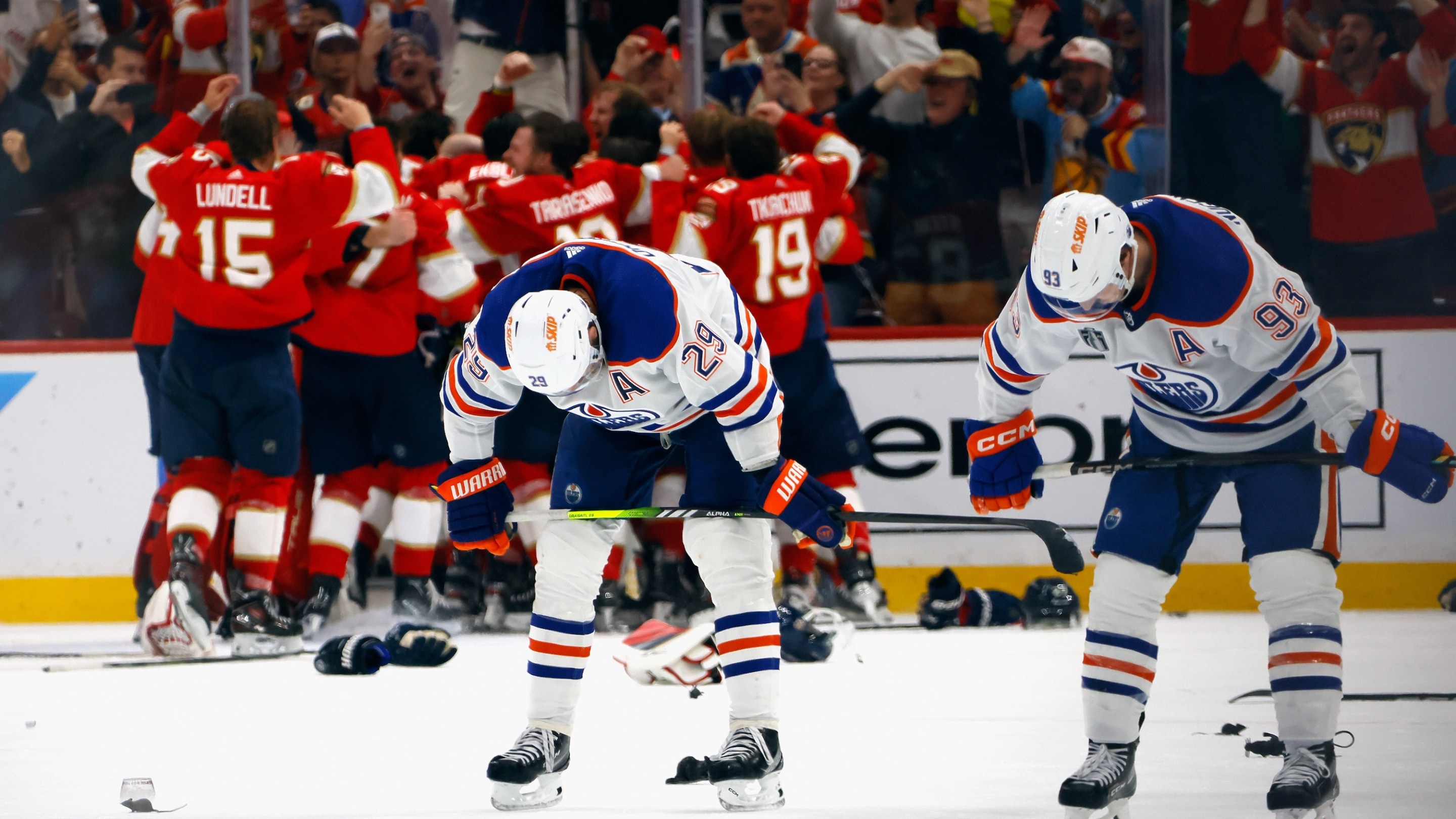 SUNRISE, FLORIDA - JUNE 24: Leon Draisaitl #29 and Ryan Nugent-Hopkins #93 of the Edmonton Oilers react as the Florida Panthers celebrate their victory over the Edmonton Oilers in Game Seven of the 2024 NHL Stanley Cup Final at Amerant Bank Arena on June 24, 2024 in Sunrise, Florida. (Photo by Bruce Bennett/Getty Images)