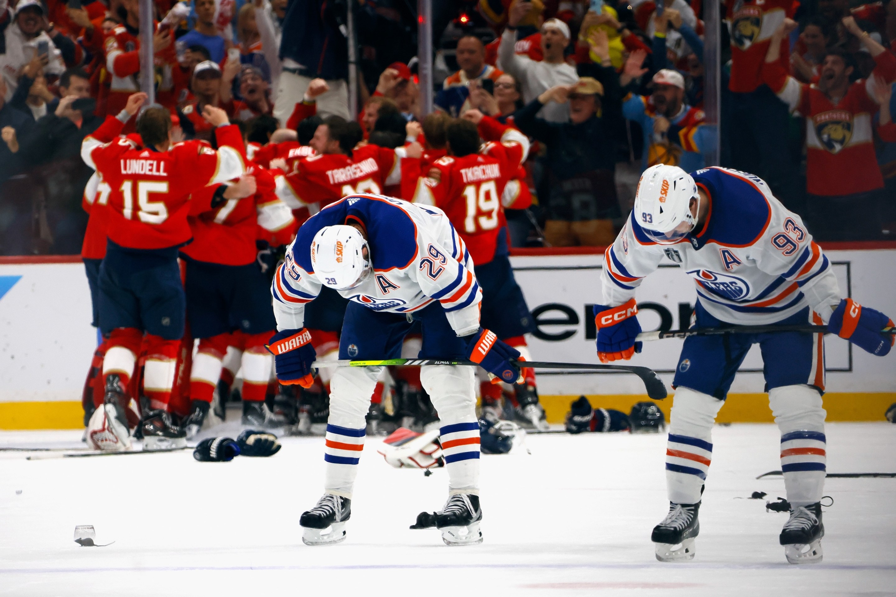 SUNRISE, FLORIDA - JUNE 24: Leon Draisaitl #29 and Ryan Nugent-Hopkins #93 of the Edmonton Oilers react as the Florida Panthers celebrate their victory over the Edmonton Oilers in Game Seven of the 2024 NHL Stanley Cup Final at Amerant Bank Arena on June 24, 2024 in Sunrise, Florida. (Photo by Bruce Bennett/Getty Images)