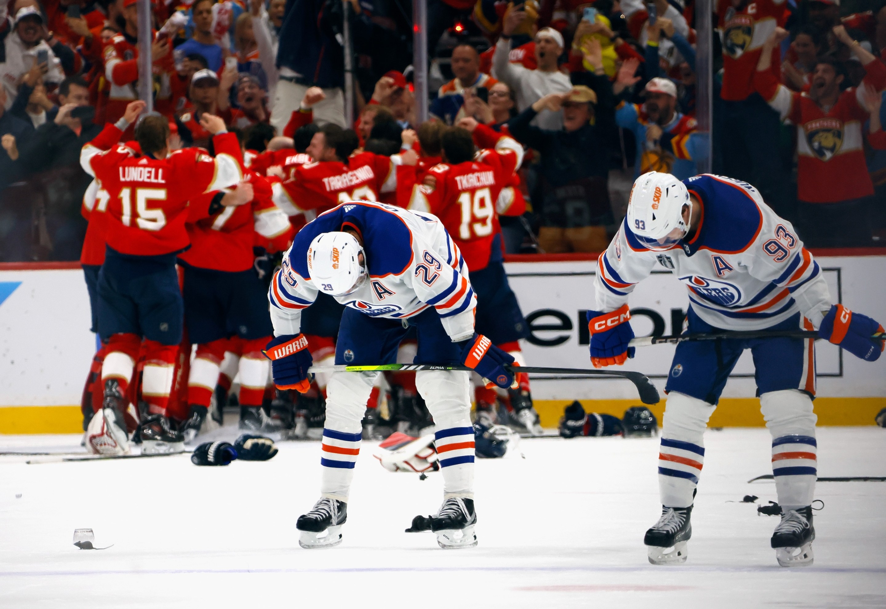 SUNRISE, FLORIDA - JUNE 24: Leon Draisaitl #29 and Ryan Nugent-Hopkins #93 of the Edmonton Oilers react as the Florida Panthers celebrate their victory over the Edmonton Oilers in Game Seven of the 2024 NHL Stanley Cup Final at Amerant Bank Arena on June 24, 2024 in Sunrise, Florida. (Photo by Bruce Bennett/Getty Images)