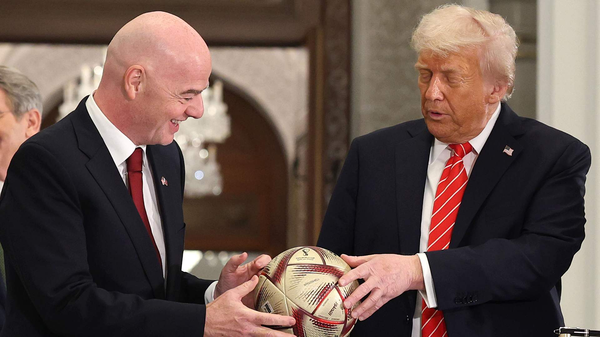 FIFA President Gianni Infantino and U.S. President Donald J. Trump sign a football during a World Cup 2026 ceremony after a state dinner at the Lusail Palace on May 14, 2025, in Doha, Qatar.
