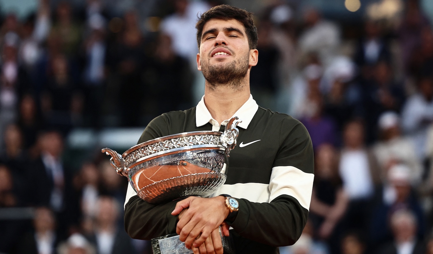 Spain's Carlos Alcaraz holds the trophy after winning the men's singles final match against Italy's Jannik Sinner on day 15 of the French Open tennis tournament on Court Philippe-Chatrier at the Roland-Garros Complex in Paris on June 8, 2025.