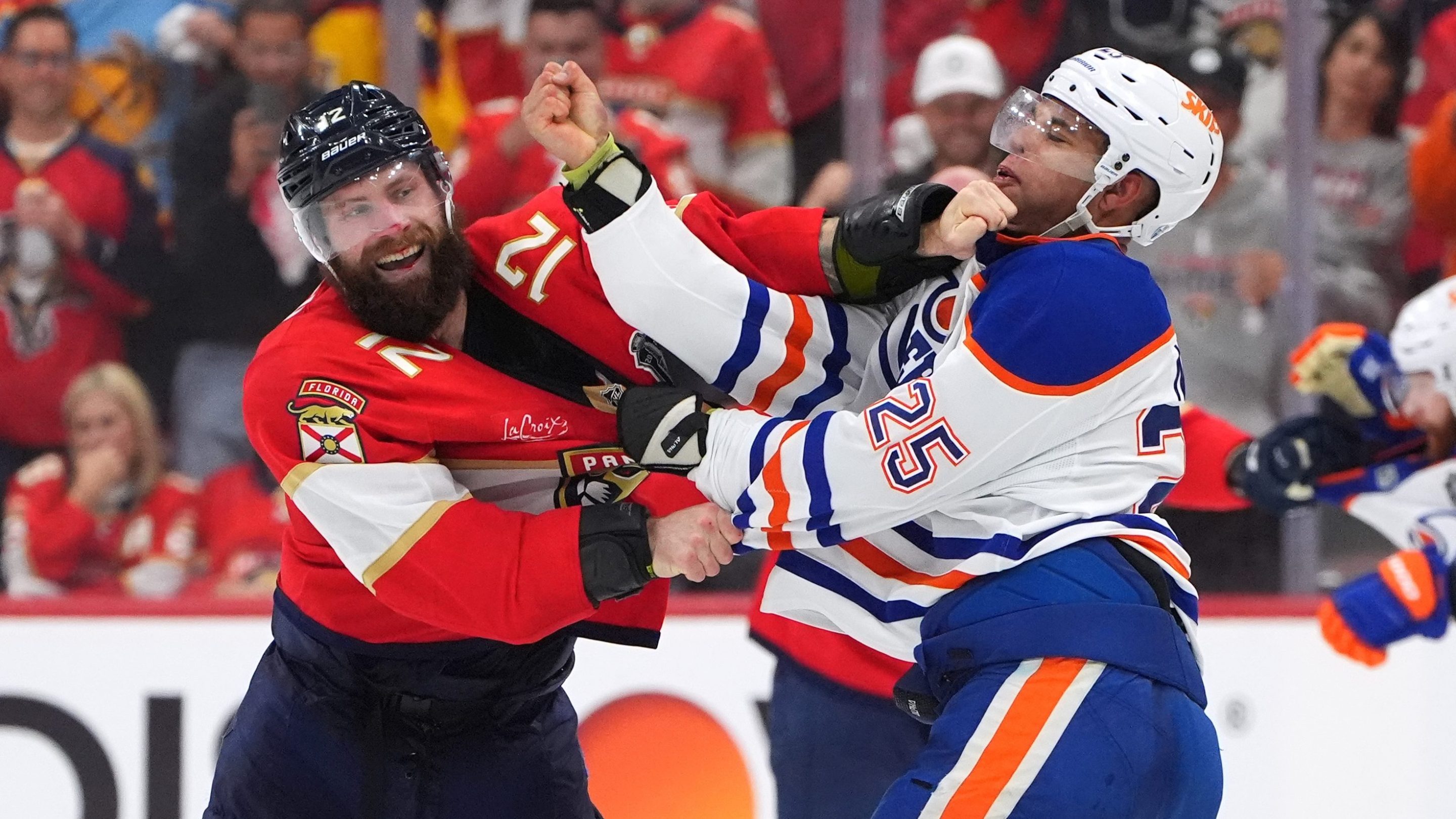 SUNRISE, FLORIDA - JUNE 09: Jonah Gadjovich #12 of the Florida Panthers tangles with Darnell Nurse #25 of the Edmonton Oilers during the third period of Game Three of the 2025 Stanley Cup Final between the Edmonton Oilers and the Florida Panthers at Amerant Bank Arena on June 09, 2025 in Sunrise, Florida. (Photo by Brian Babineau/NHLI via Getty Images)