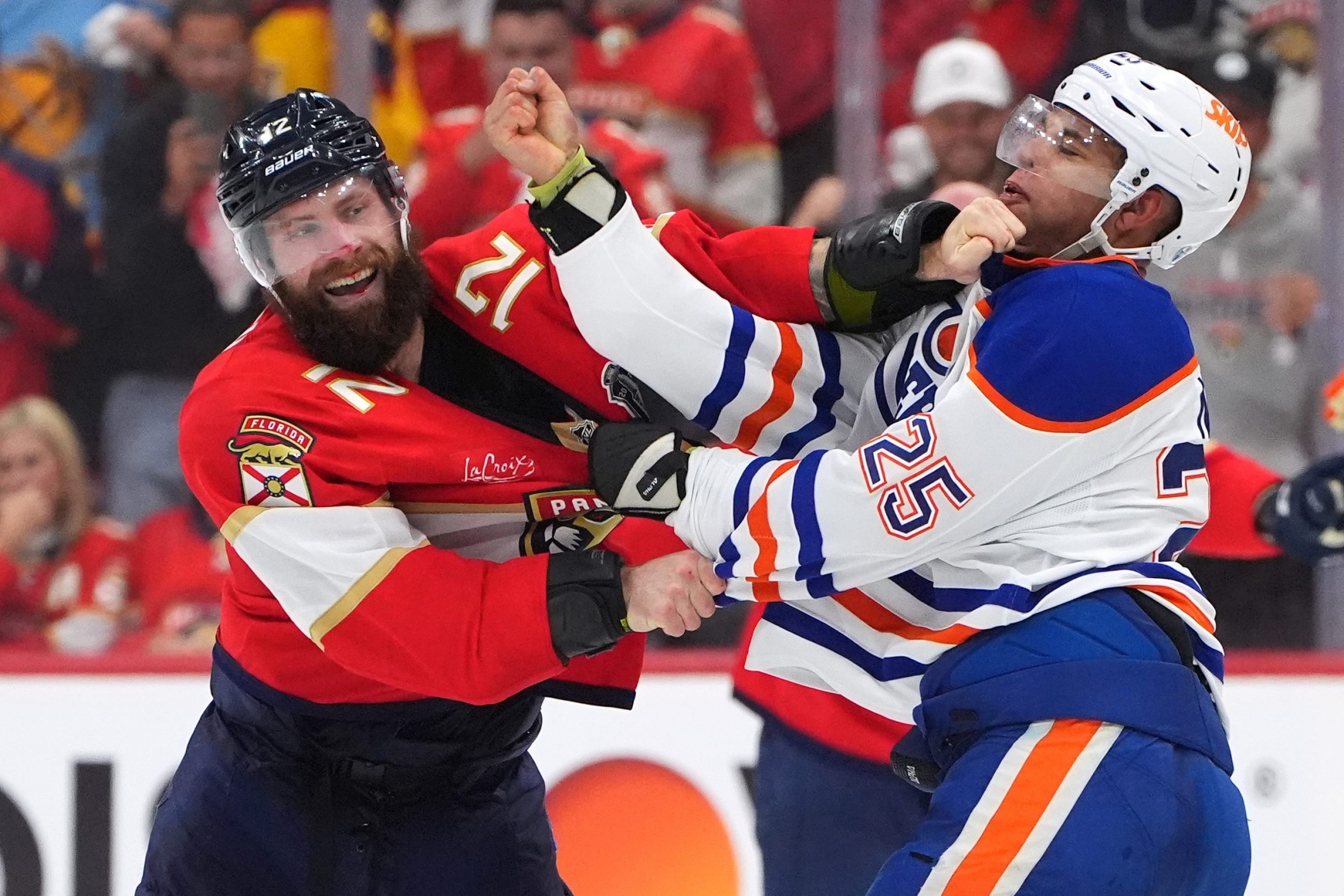SUNRISE, FLORIDA - JUNE 09: Jonah Gadjovich #12 of the Florida Panthers tangles with Darnell Nurse #25 of the Edmonton Oilers during the third period of Game Three of the 2025 Stanley Cup Final between the Edmonton Oilers and the Florida Panthers at Amerant Bank Arena on June 09, 2025 in Sunrise, Florida. (Photo by Brian Babineau/NHLI via Getty Images)