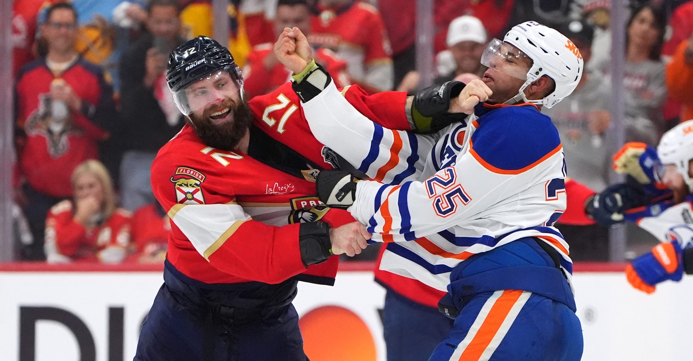 SUNRISE, FLORIDA - JUNE 09: Jonah Gadjovich #12 of the Florida Panthers tangles with Darnell Nurse #25 of the Edmonton Oilers during the third period of Game Three of the 2025 Stanley Cup Final between the Edmonton Oilers and the Florida Panthers at Amerant Bank Arena on June 09, 2025 in Sunrise, Florida. (Photo by Brian Babineau/NHLI via Getty Images)
