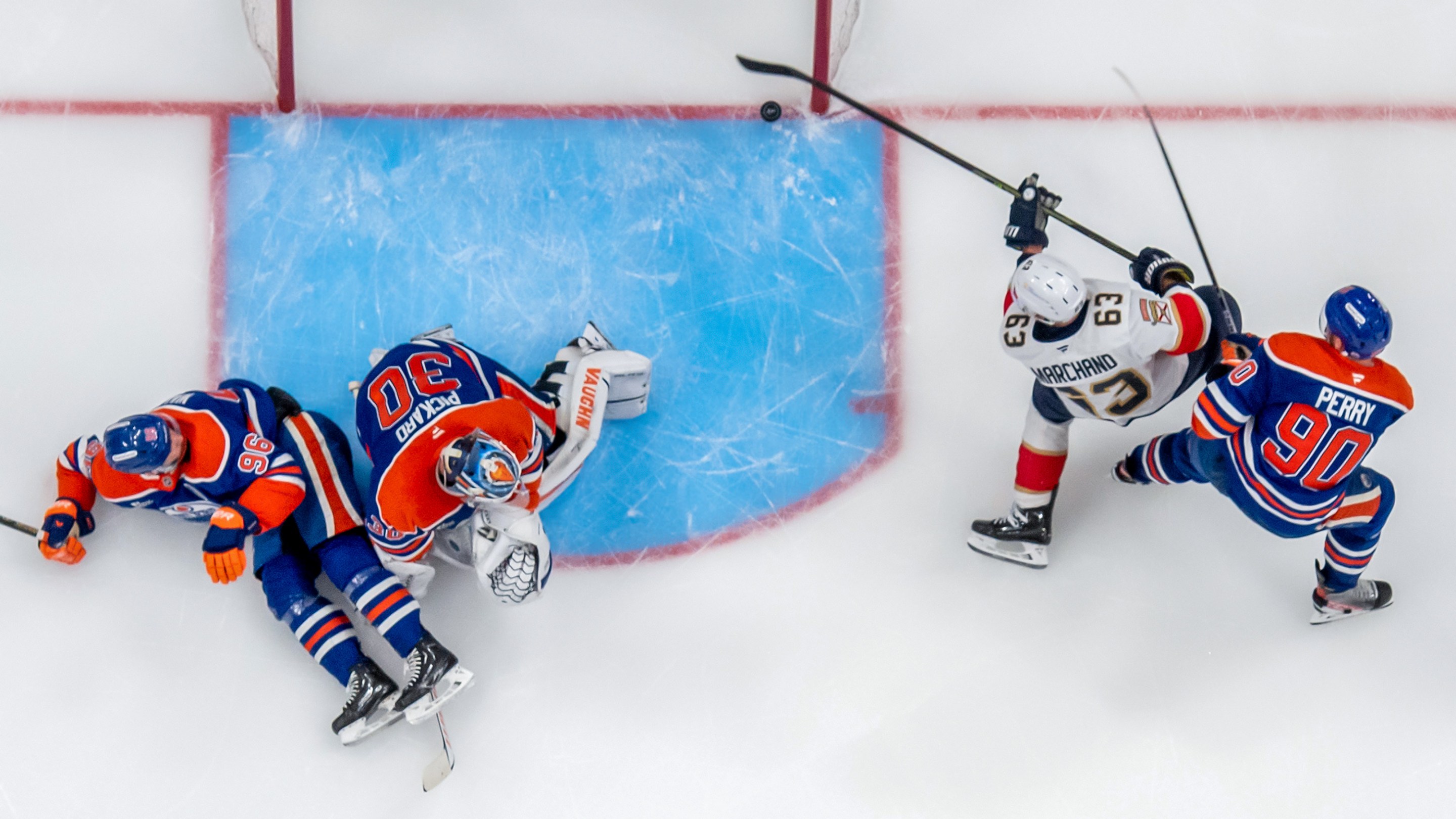 Brad Marchand #63 of the Florida Panthers shoots the puck into the net behind goaltender Calvin Pickard #30, Corey Perry #90, and Jake Walman #96 of the Edmonton Oilers