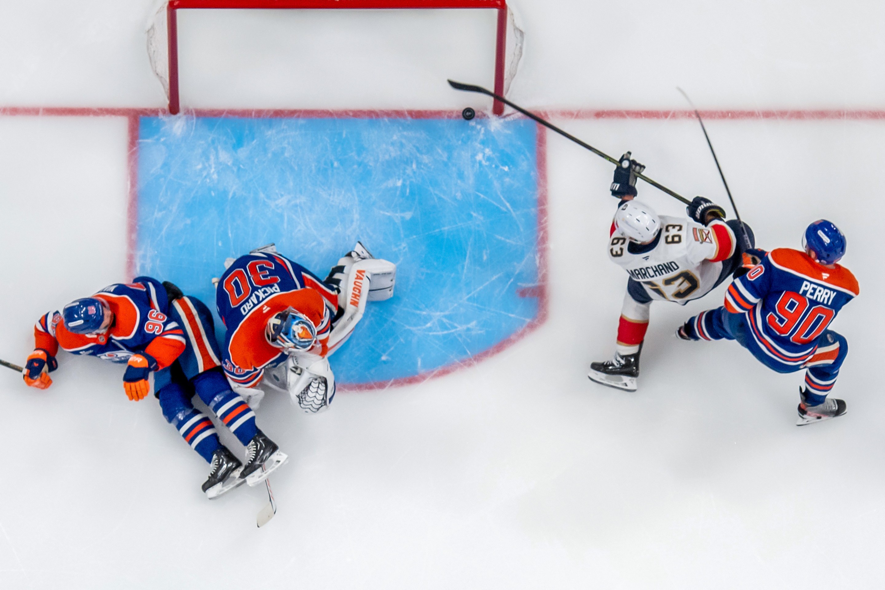 Brad Marchand #63 of the Florida Panthers shoots the puck into the net behind goaltender Calvin Pickard #30, Corey Perry #90, and Jake Walman #96 of the Edmonton Oilers