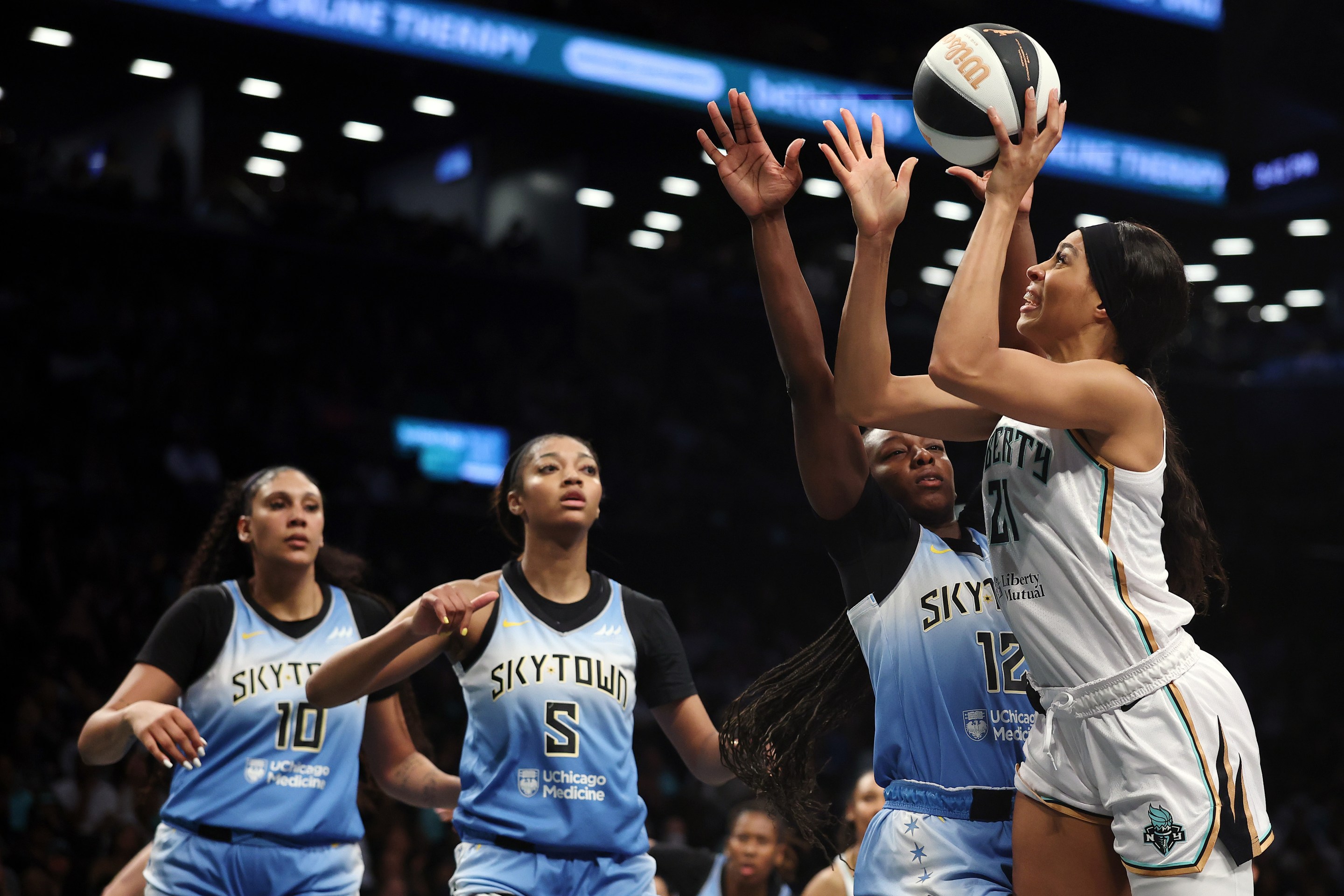 Isabelle Harrison #21 of the New York Liberty goes to the basket as Michaela Onyenwere #12, Angel Reese #5, and Kamilla Cardoso #10 of the Chicago Sky defend during the second half at Barclays Center on June 10, 2025 in the Brooklyn borough of New York City. The Liberty won 85-66.