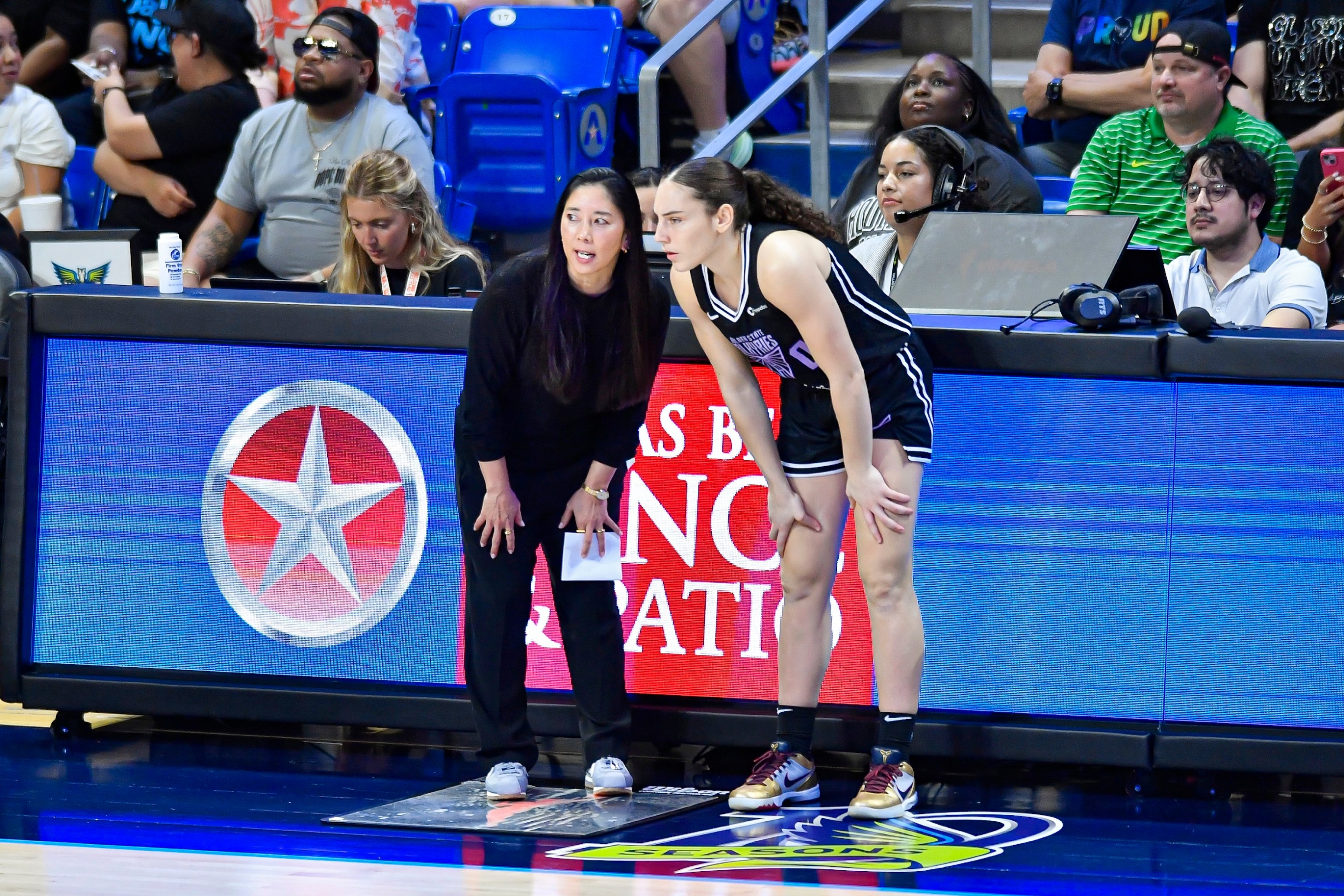 Golden State Valkyries coach Natalie Nakase (left) talks with guard Carla Leite (right) during the second quarter of a WNBA game between the Golden State Valkyries and Dallas Wings on Tuesday, June 17, 2025 at College Park Center in Arlington, TX.