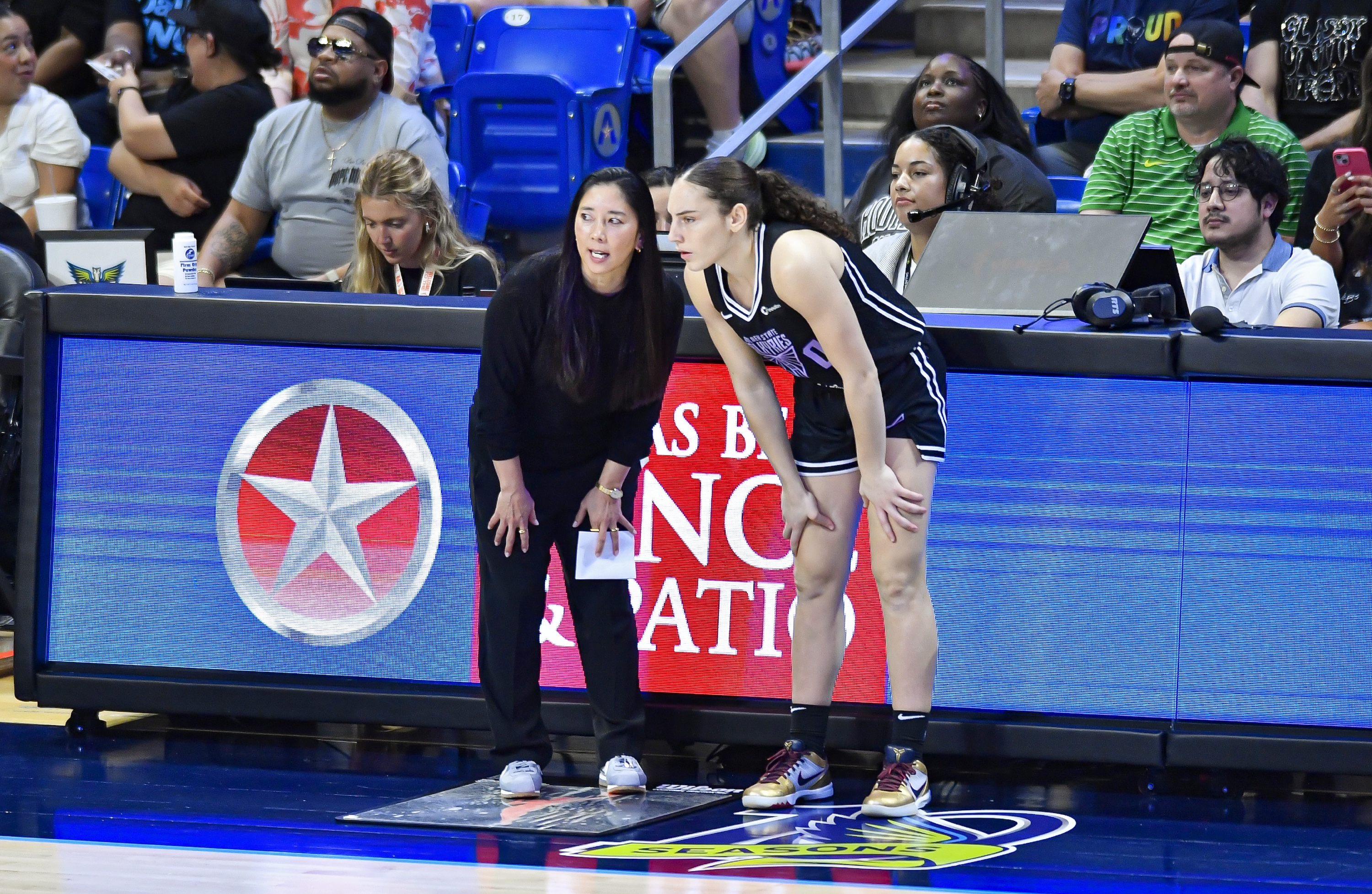 Golden State Valkyries coach Natalie Nakase (left) talks with guard Carla Leite (right) during the second quarter of a WNBA game between the Golden State Valkyries and Dallas Wings on Tuesday, June 17, 2025 at College Park Center in Arlington, TX.