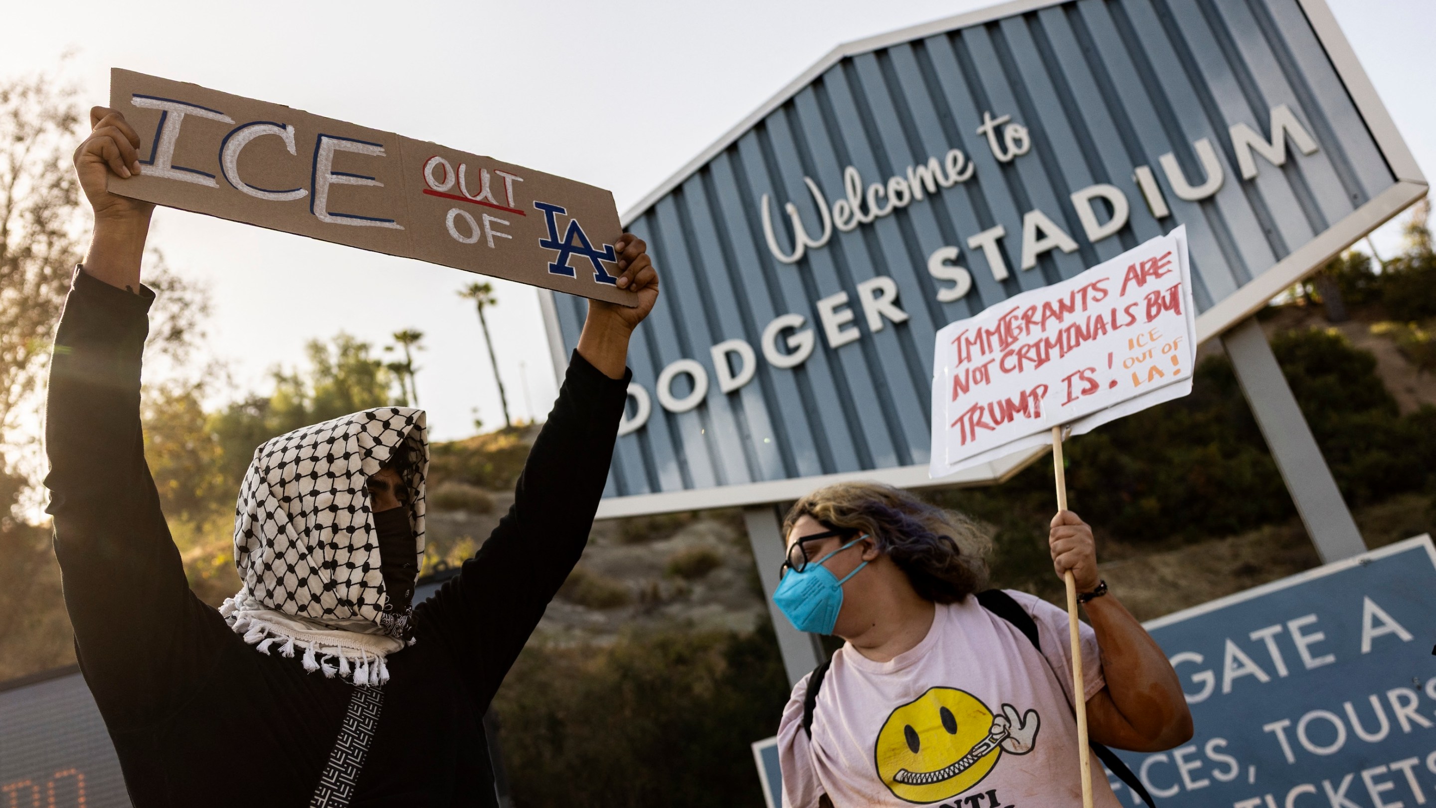 A small group of demonstrators protests outside the entrance of Dodger Stadium on the night of the team's June 19 game.