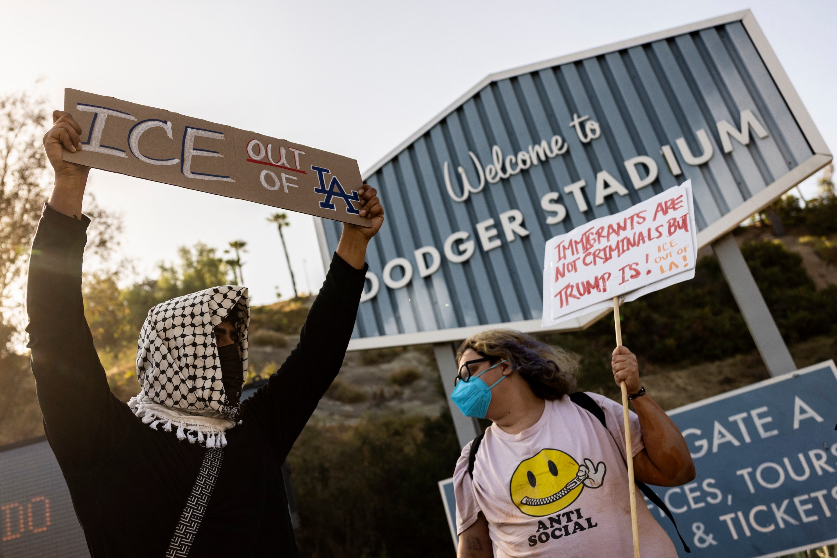 A small group of demonstrators protests outside the entrance of Dodger Stadium on the night of the team's June 19 game.
