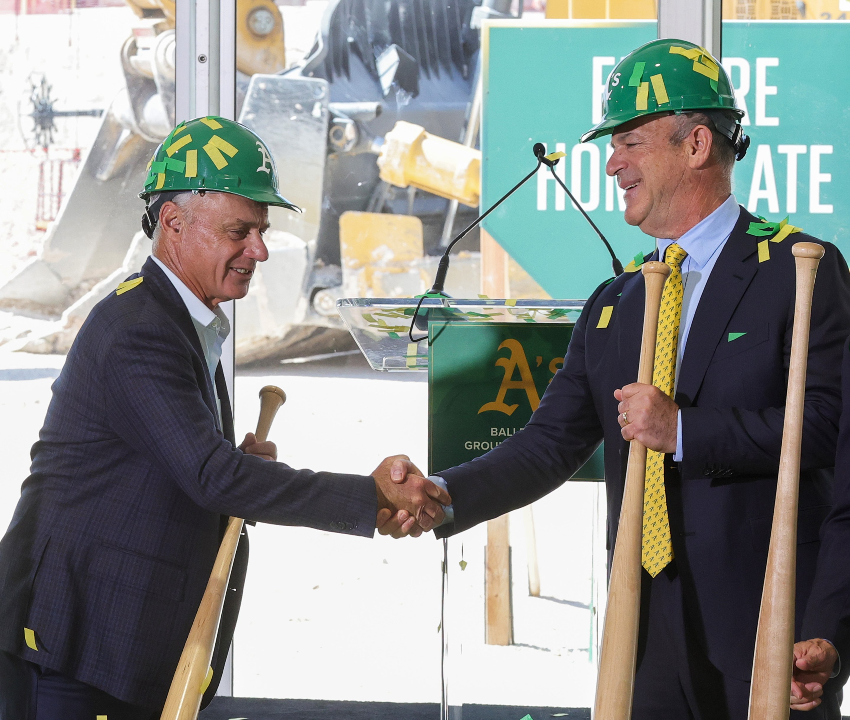 Major League Baseball Commissioner Rob Manfred (L) and principal owner John Fisher of the Athletics shake hands after participating in a ceremonial groundbreaking for the A's new stadium in Las Vegas.