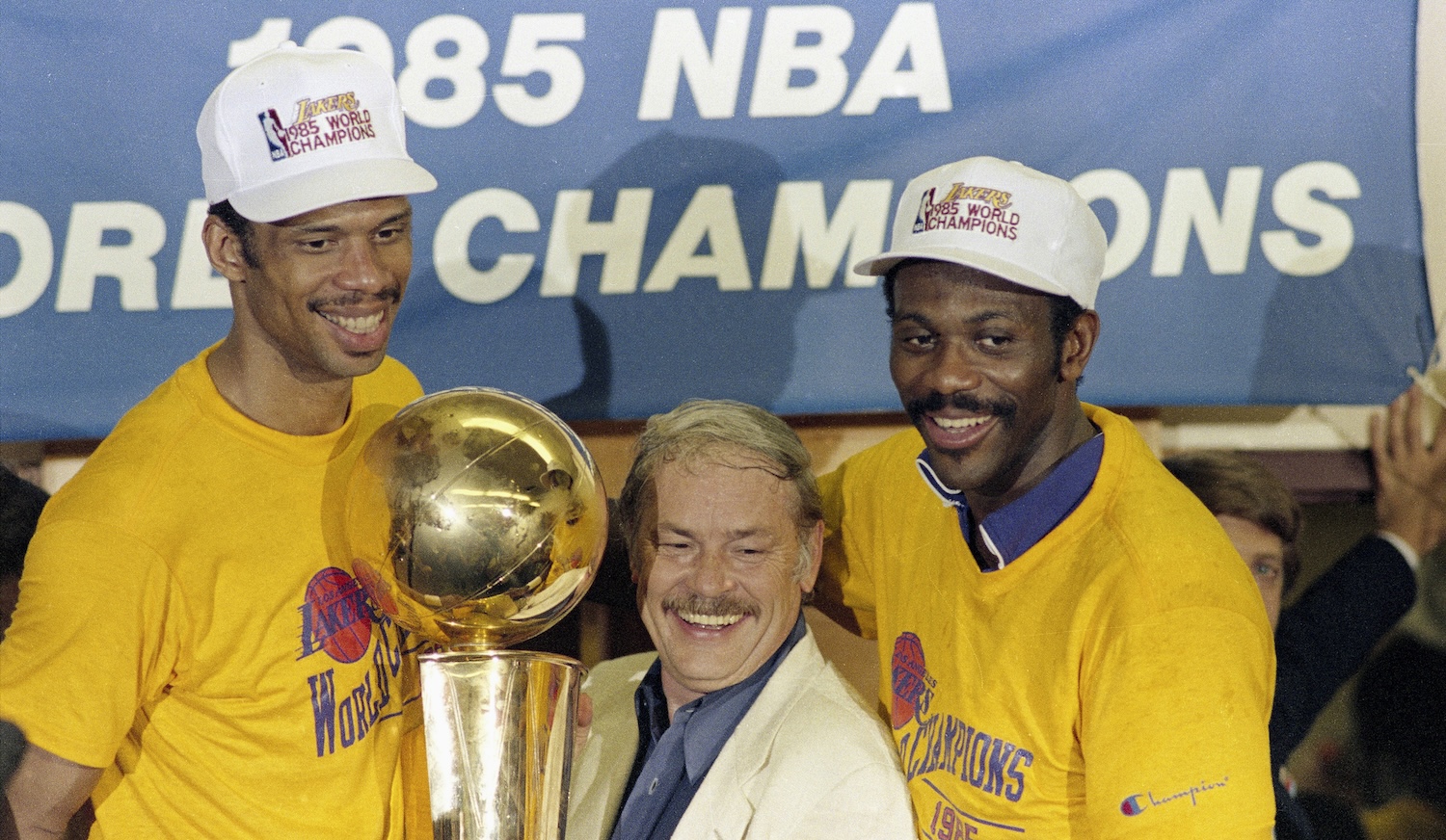 Basketball: NBA Finals: Los Angeles Lakers owner Jerry Buss victorious holding Larry O'Brien NBA Championship Trophy with Kareen Abdul-Jabbar (L) and Bob McAdoo after winning game and series vs Boston Celtics at Boston Garden. Game 6.