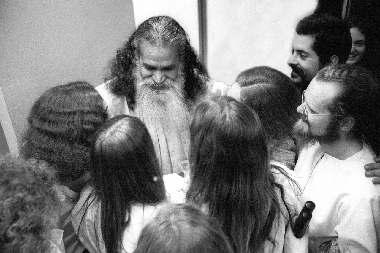 Swami Satchidananda arrives at the San Francisco Airport on April 4, 1971 in San Francisco, California. He is surrounded by people who appear very excited about his arrival.