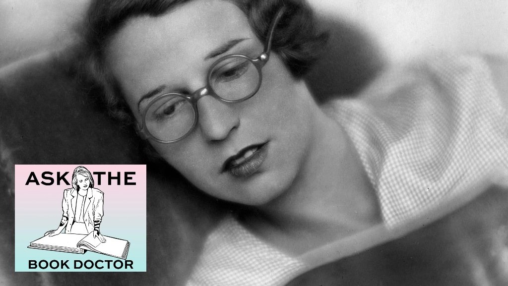 black and white photo of a woman reading with glasses on
