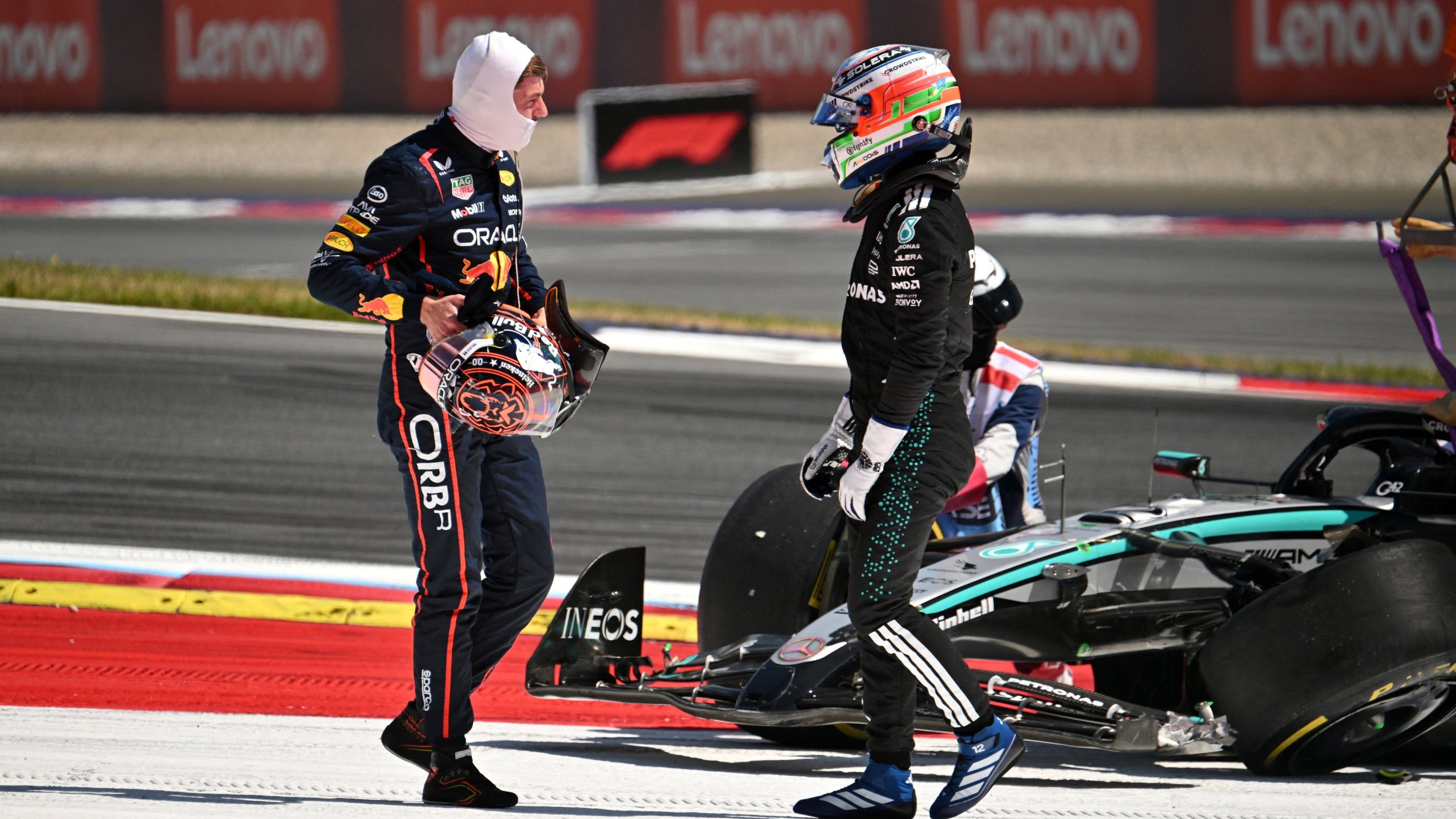 Red Bull's Dutch driver Max Verstappen (L) and Mercedes' Italian driver Kimi Antonelli speak after their cars crashed.