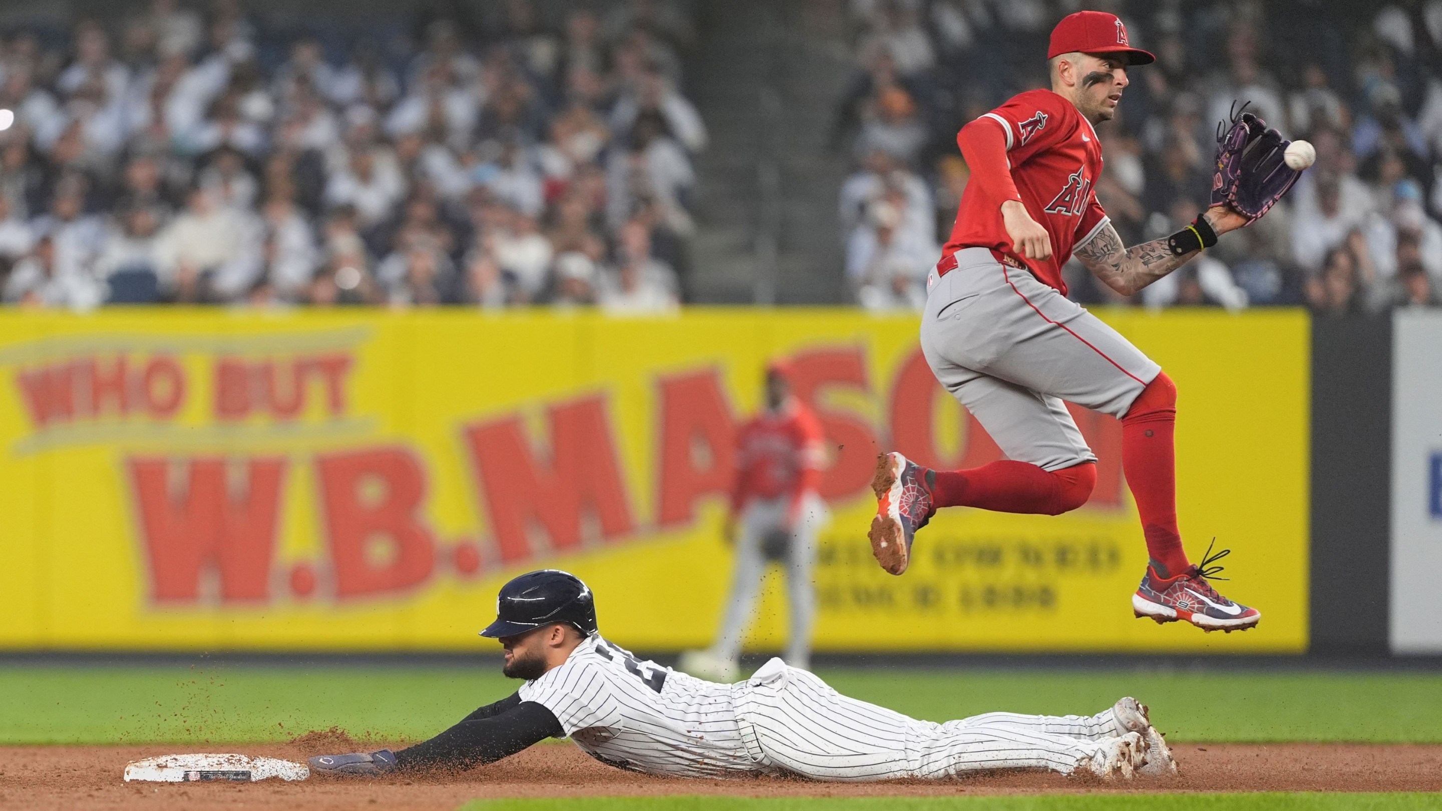 New York Yankees Left Fielder Jasson Dominguez (24) steals second base with Los Angeles Angels Shortstop Zach Neto (9) catching the throw.