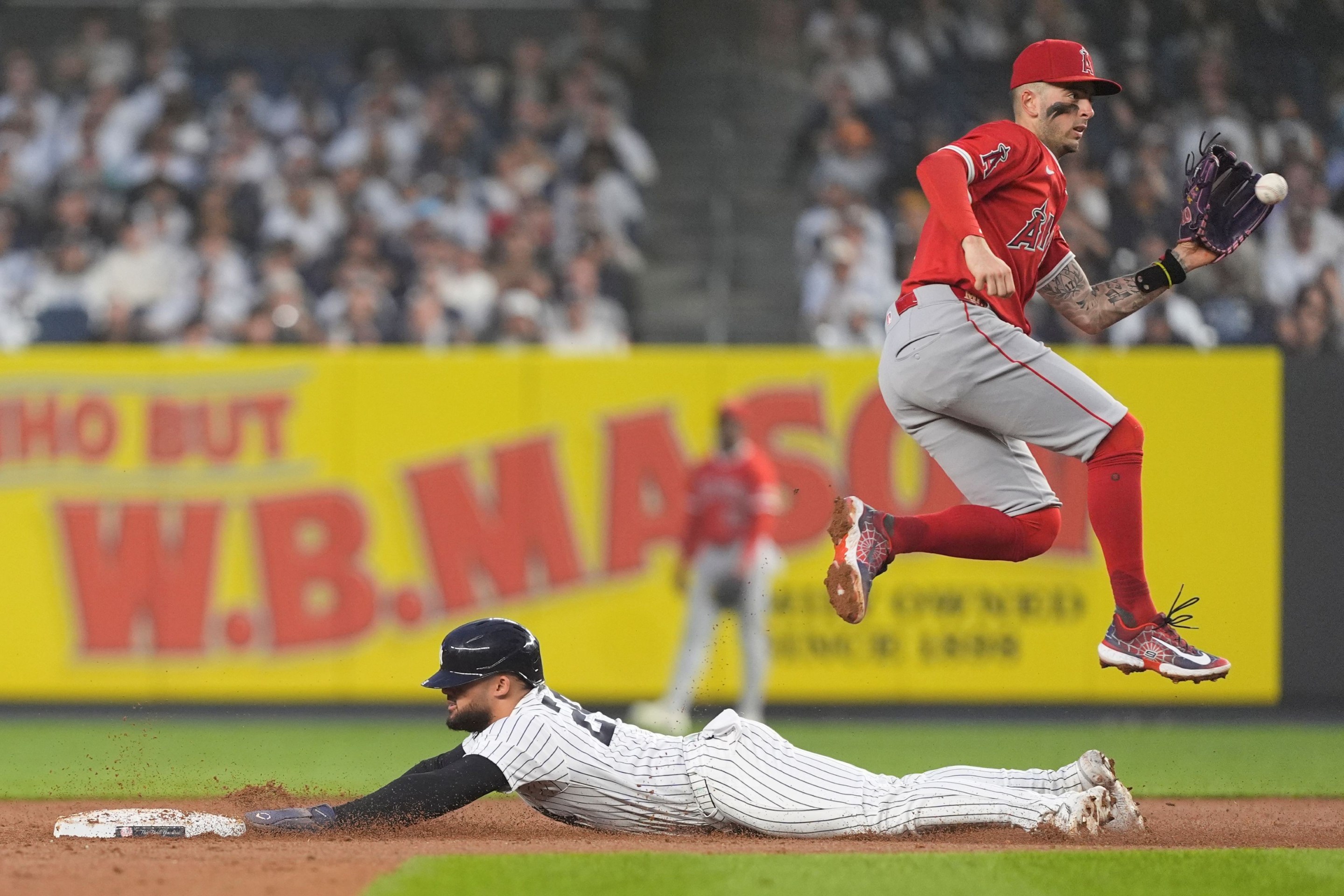 New York Yankees Left Fielder Jasson Dominguez (24) steals second base with Los Angeles Angels Shortstop Zach Neto (9) catching the throw.