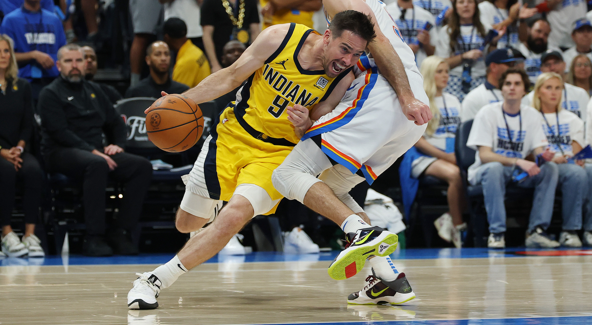 T.J. McConnell #9 of the Indiana Pacers drives to the basket against Alex Caruso #9 of the Oklahoma City Thunder during the third quarter in Game Five of the 2025 NBA Finals.