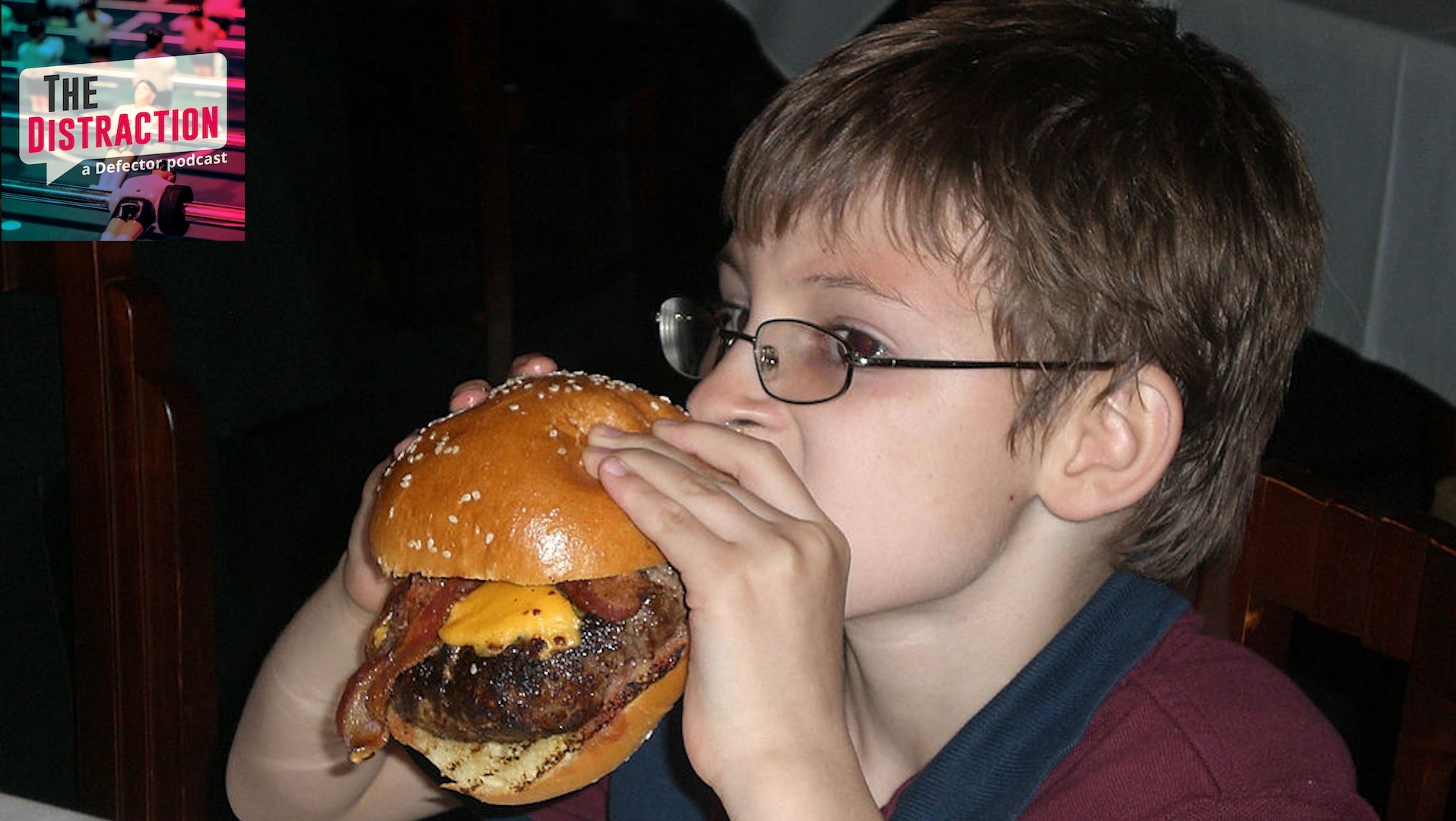 Ten-year-old Eli Knauer takes a bite from a bacon cheeseburger twice wider than his face on May 27, 2011 at Morton's Steakhouse in Baltimore, Maryland.