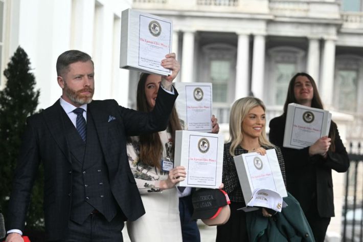 (From L) Political commentator Rogan O'Handley, aka DC Draino, TikToker Chaya Raichik, commentator Liz Wheeler and US conservative activist Scott Presler carry binders bearing the seal of the US Justice Department reading "The Epstein Files: Phase 1" as they walk out of the West Wing of the White House in Washington, DC, on February 27, 2025. The Trump administration has said it would release documents on late tycoon and convicted sex trafficker Jeffrey Epstein who was found dead in his prison cell in 2019. (Photo by Jim WATSON / AFP)