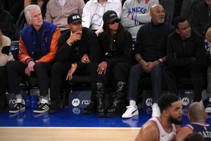 Russell Wilson wearing a hat that says REAL