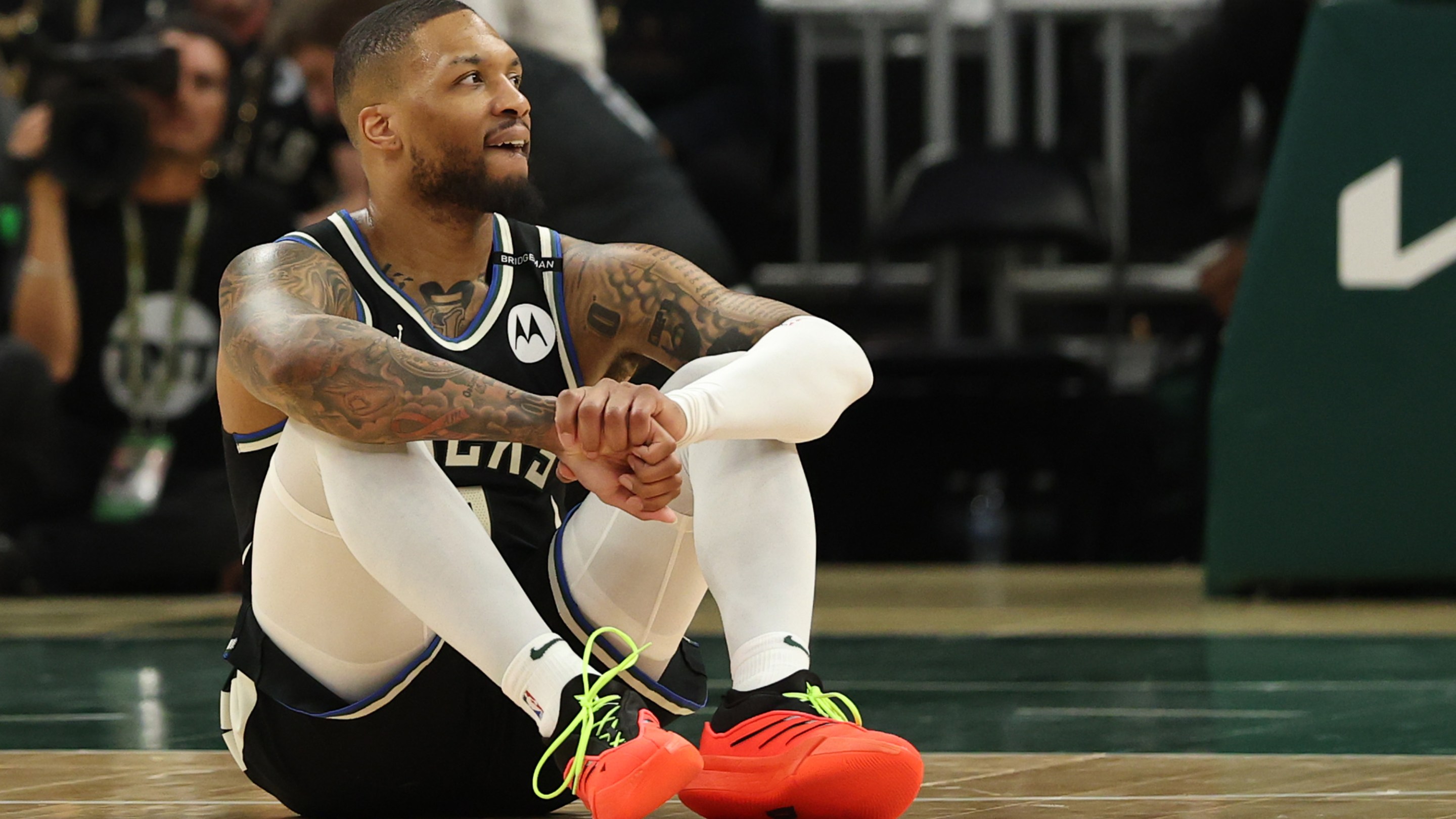 Damian Lillard #0 of the Milwaukee Bucks reacts from the court after an apparent injury during the first quarter in Game Four of the Eastern Conference First Round NBA Playoffs against the Indiana Pacers at Fiserv Forum on April 27, 2025 in Milwaukee, Wisconsin.