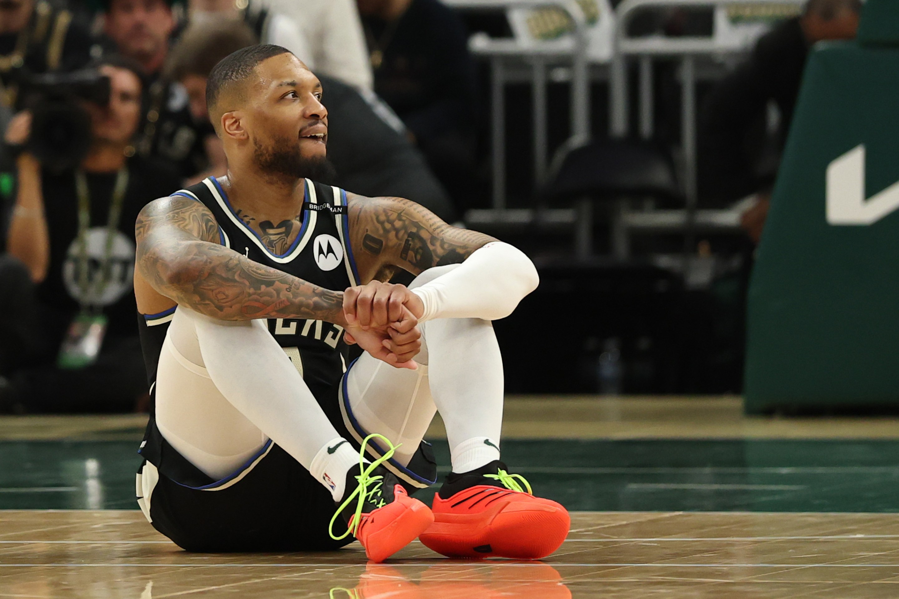 Damian Lillard #0 of the Milwaukee Bucks reacts from the court after an apparent injury during the first quarter in Game Four of the Eastern Conference First Round NBA Playoffs against the Indiana Pacers at Fiserv Forum on April 27, 2025 in Milwaukee, Wisconsin.