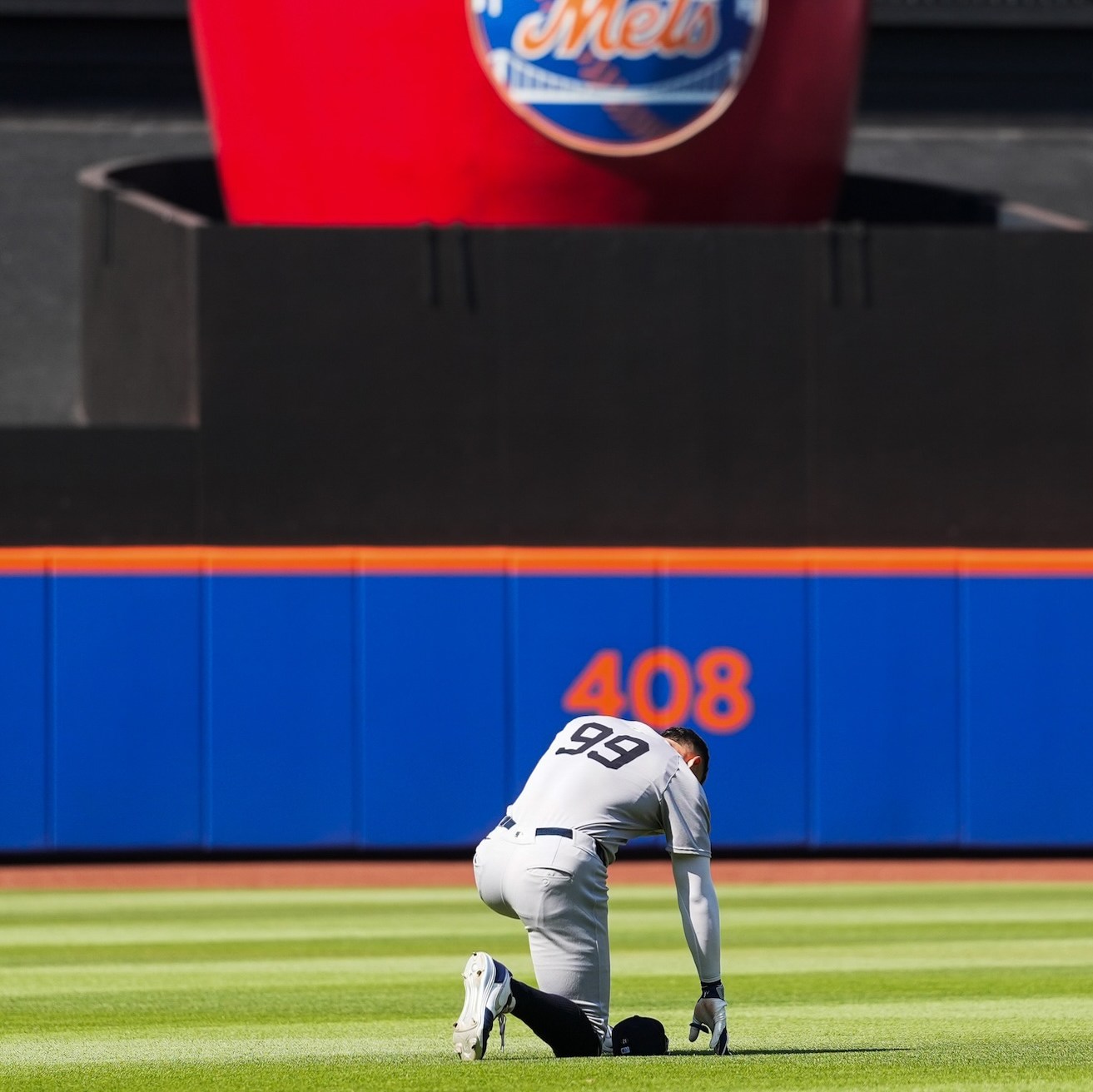 NEW YORK, NY - JULY 05: Aaron Judge #99 of the New York Yankees kneels in the outfield during the game between the New York Yankees and the New York Mets at Citi Field on Saturday, July 5, 2025 in New York, New York. (Photo by Evan Yu/MLB Photos via Getty Images)