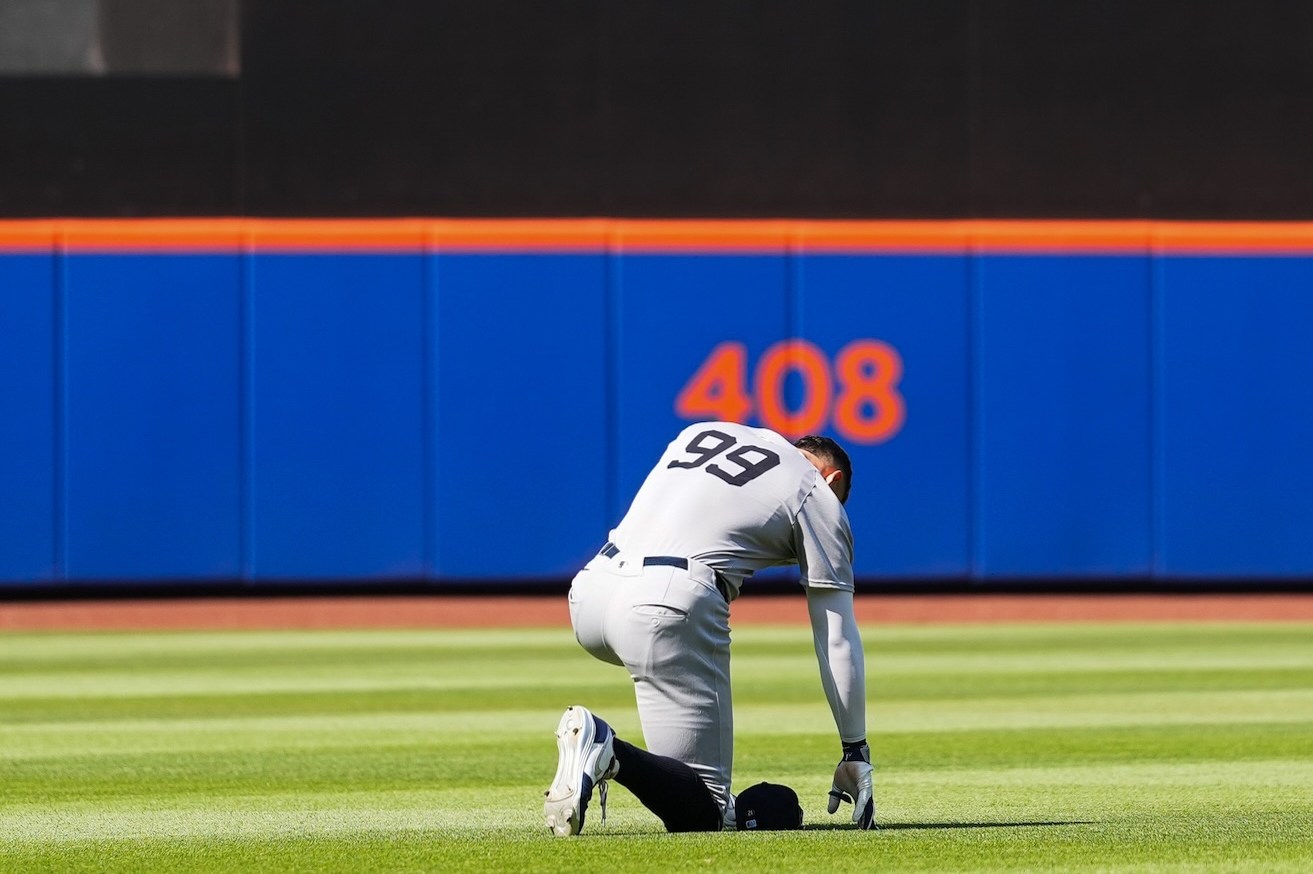 NEW YORK, NY - JULY 05: Aaron Judge #99 of the New York Yankees kneels in the outfield during the game between the New York Yankees and the New York Mets at Citi Field on Saturday, July 5, 2025 in New York, New York. (Photo by Evan Yu/MLB Photos via Getty Images)