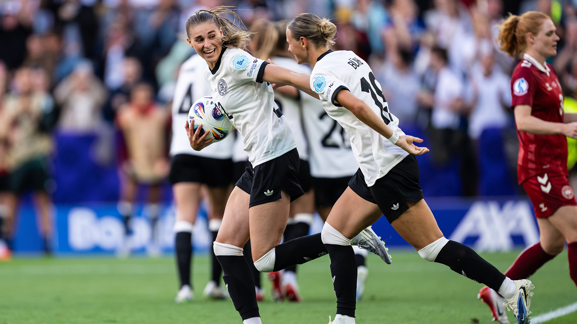 Jule Brand and Klara Buehl (L-R) of Germany celebrate after her team's first goal during the UEFA Women's EURO 2025 Group C match between Germany and Denmark at St. Jakob-Park on July 08, 2025 in Basel, Switzerland.
