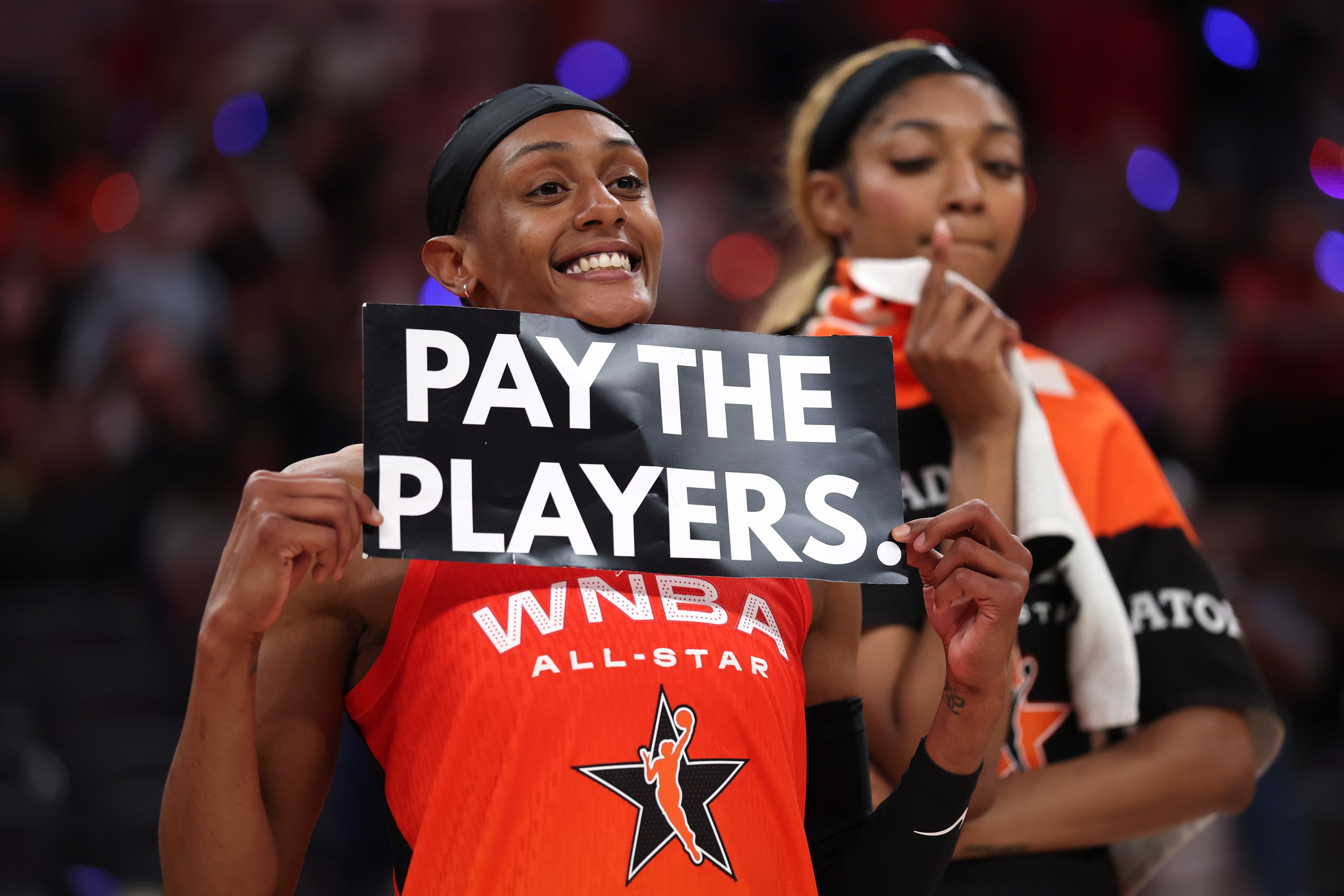 Brittney Sykes #15 of the Washington Mystics holds a "Pay the Players" sign following the 2025 AT&amp;T WNBA All-Star Game at Gainbridge Fieldhouse on July 19, 2025 in Indianapolis, Indiana.