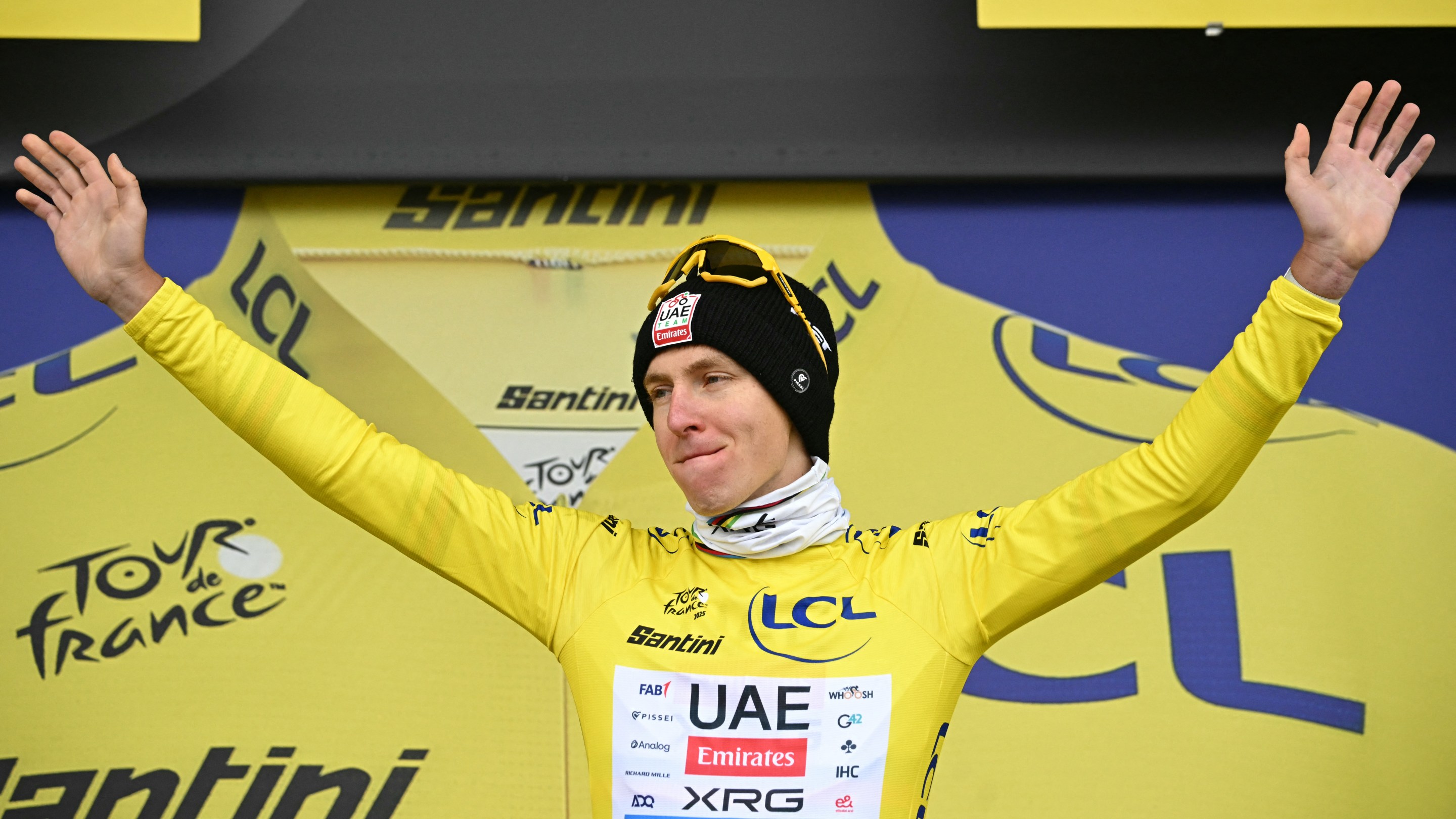 Tadej Pogacar celebrates on the podium with the overall leader's yellow jersey after the 20th stage of the 112th edition of the Tour de France cycling race