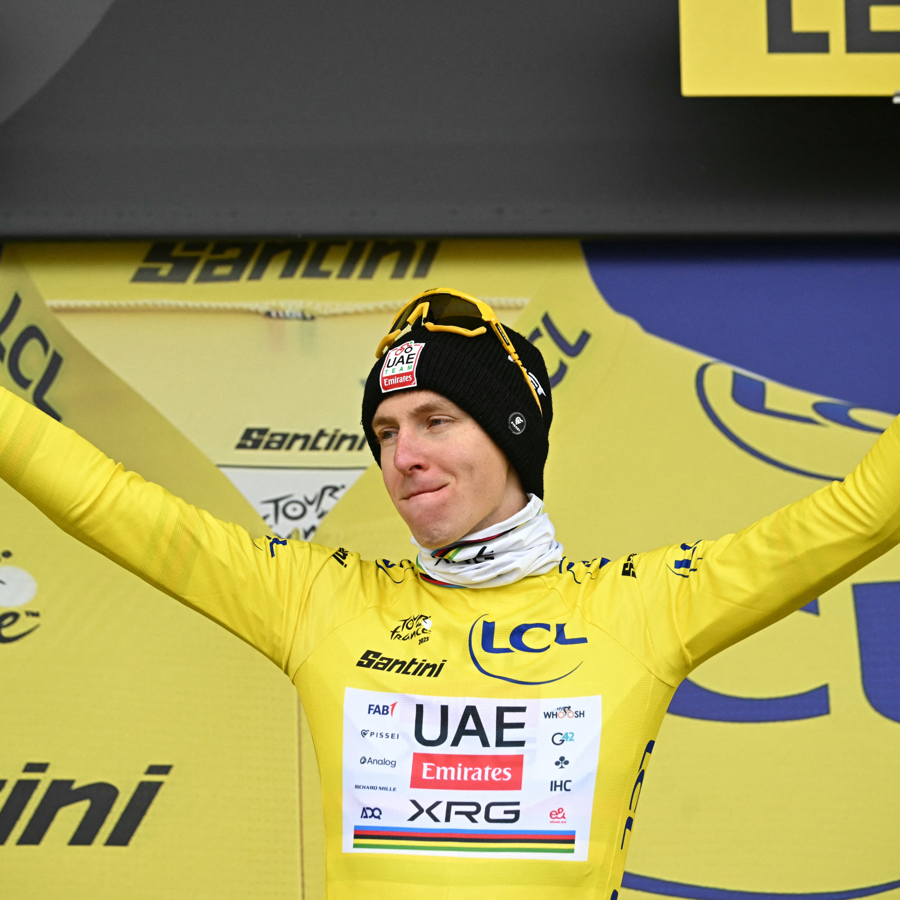 Tadej Pogacar celebrates on the podium with the overall leader's yellow jersey after the 20th stage of the 112th edition of the Tour de France cycling race