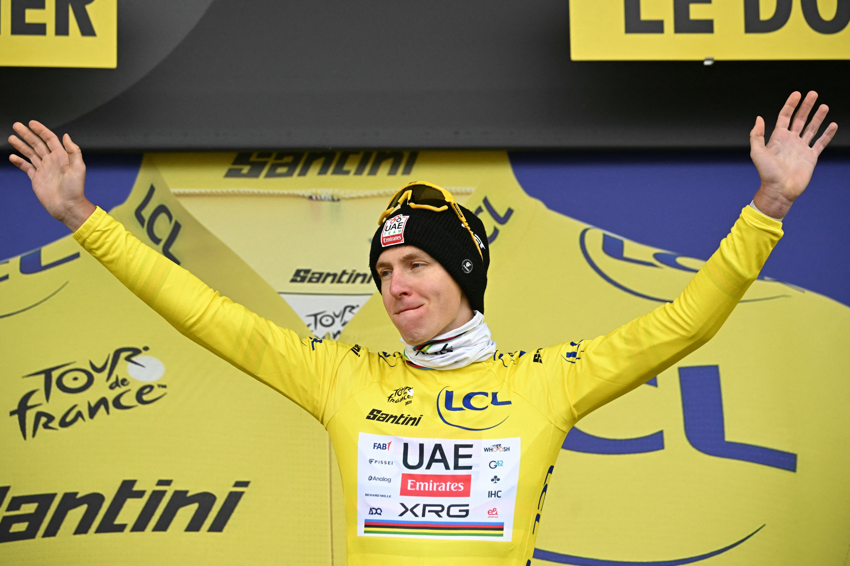 Tadej Pogacar celebrates on the podium with the overall leader's yellow jersey after the 20th stage of the 112th edition of the Tour de France cycling race