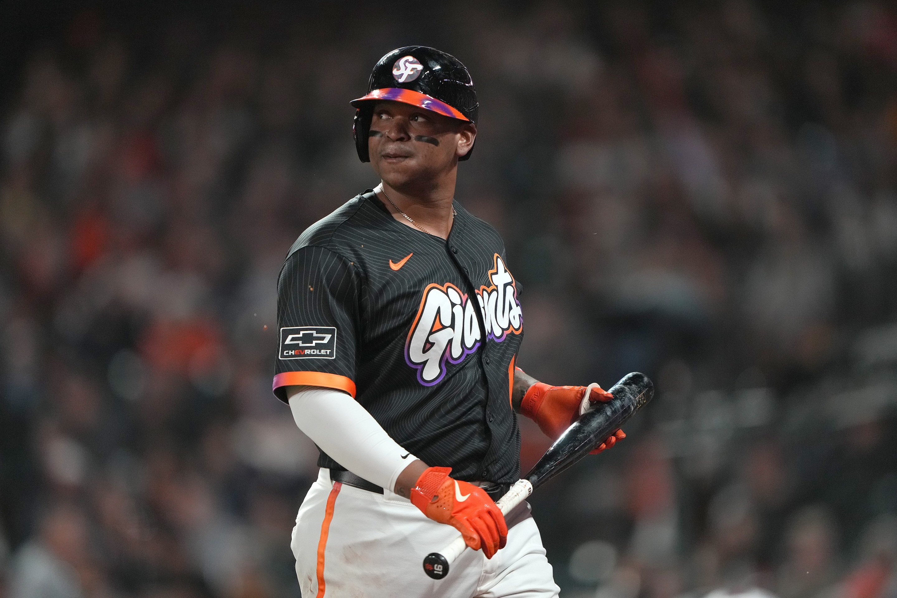 Rafael Devers of the San Francisco Giants looks on walking back to the dugout after striking out against the Pittsburgh Pirates in the bottom of the ninth.