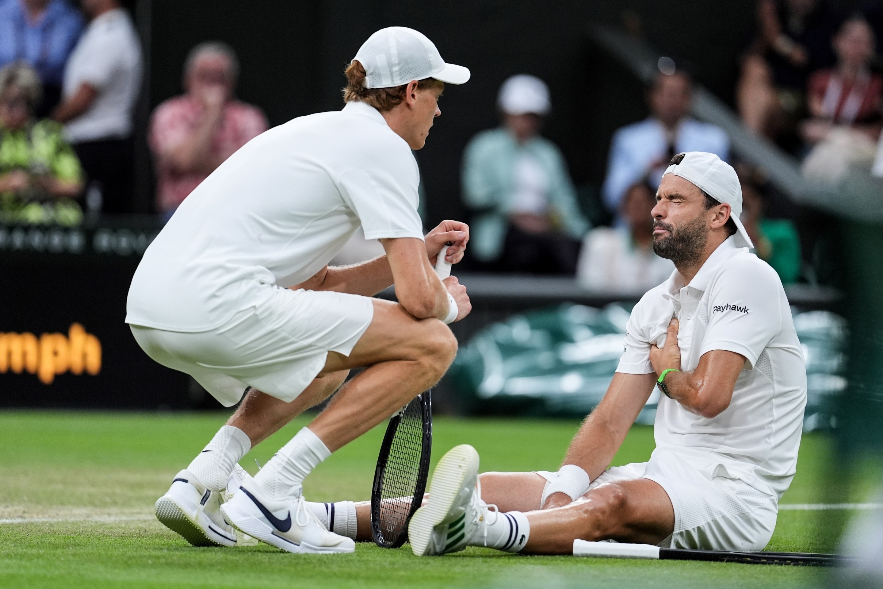 Grigor Dimitrov of Bulgaria gets an injury in the Gentlemen's Singles Fourth Round match against Jannik Sinner of Italy on day eight of The Championships Wimbledon 2025 at All England Lawn Tennis and Croquet Club on July 07, 2025 in London, England.