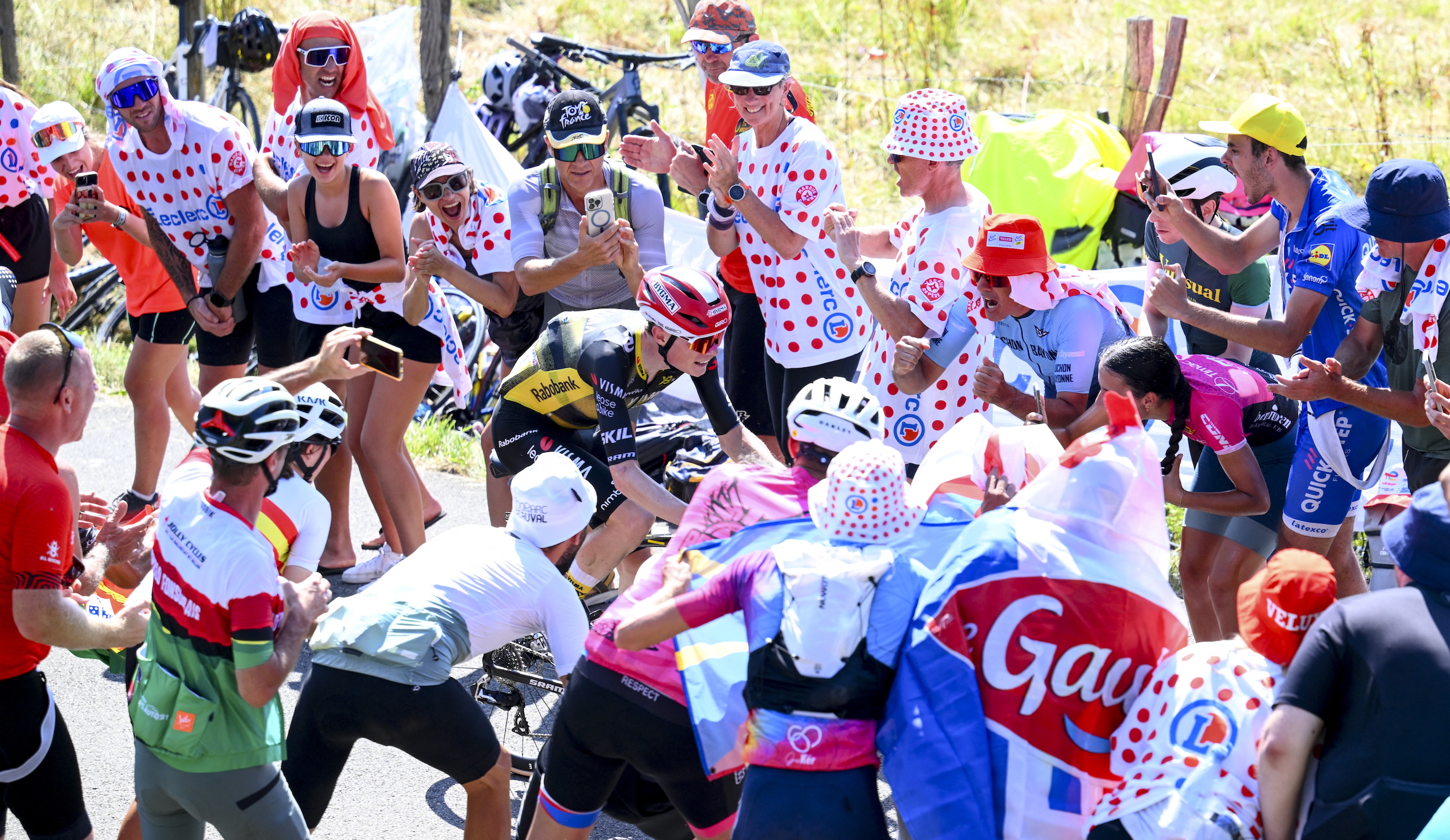 Fans throng a rider on the way up the Hautacam during Stage 12 of the 2025 Tour de France.