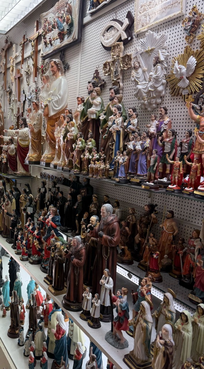Shelves of religious-themed knickknacks on display in a shop in Lourdes, France.