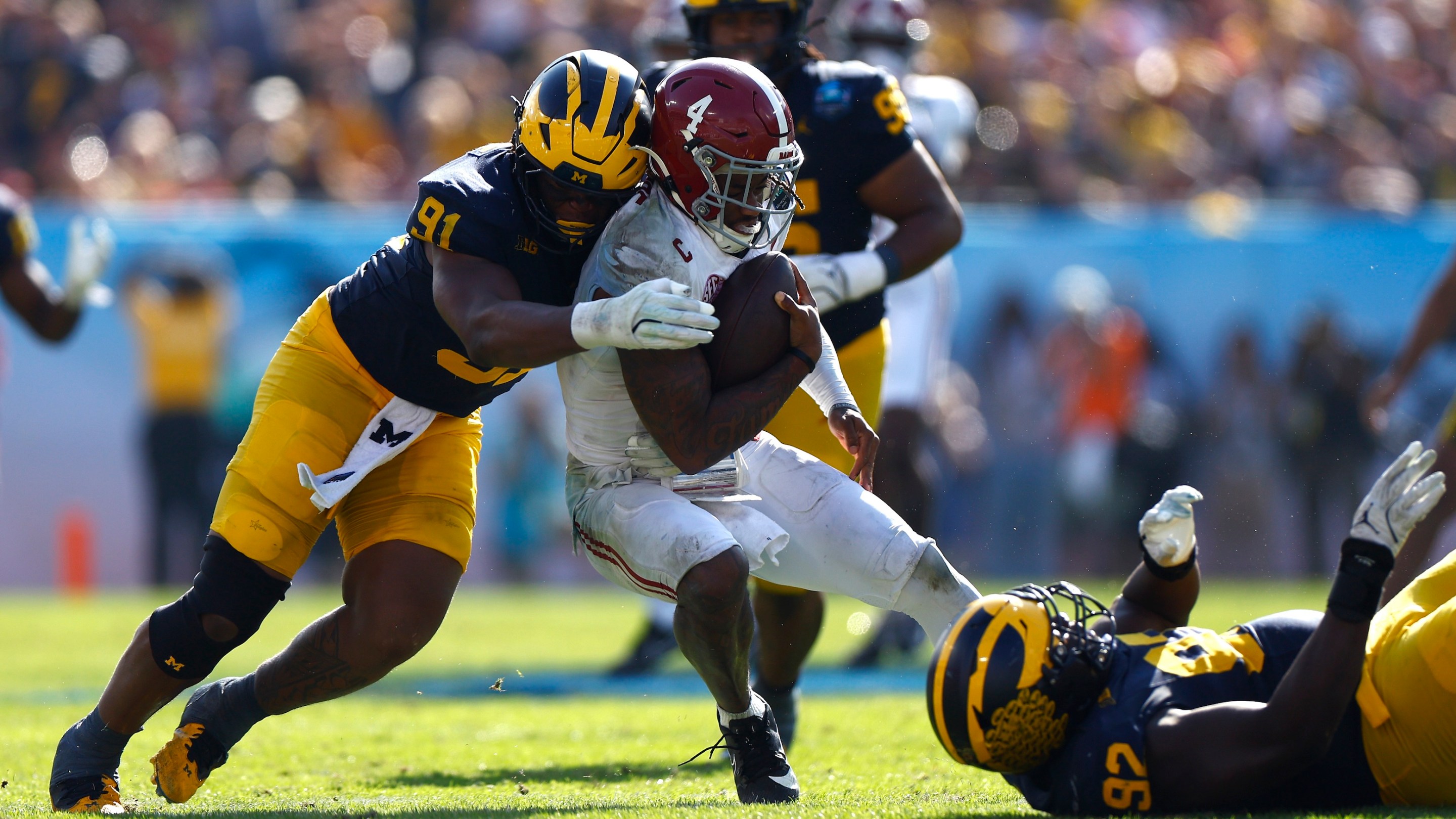 Jalen Milroe #4 of the Alabama Crimson Tide is sacked by Cameron Brandt #91 of the Michigan Wolverines during the third quarter in the 2024 ReliaQuest Bowl at Raymond James Stadium on December 31, 2024.